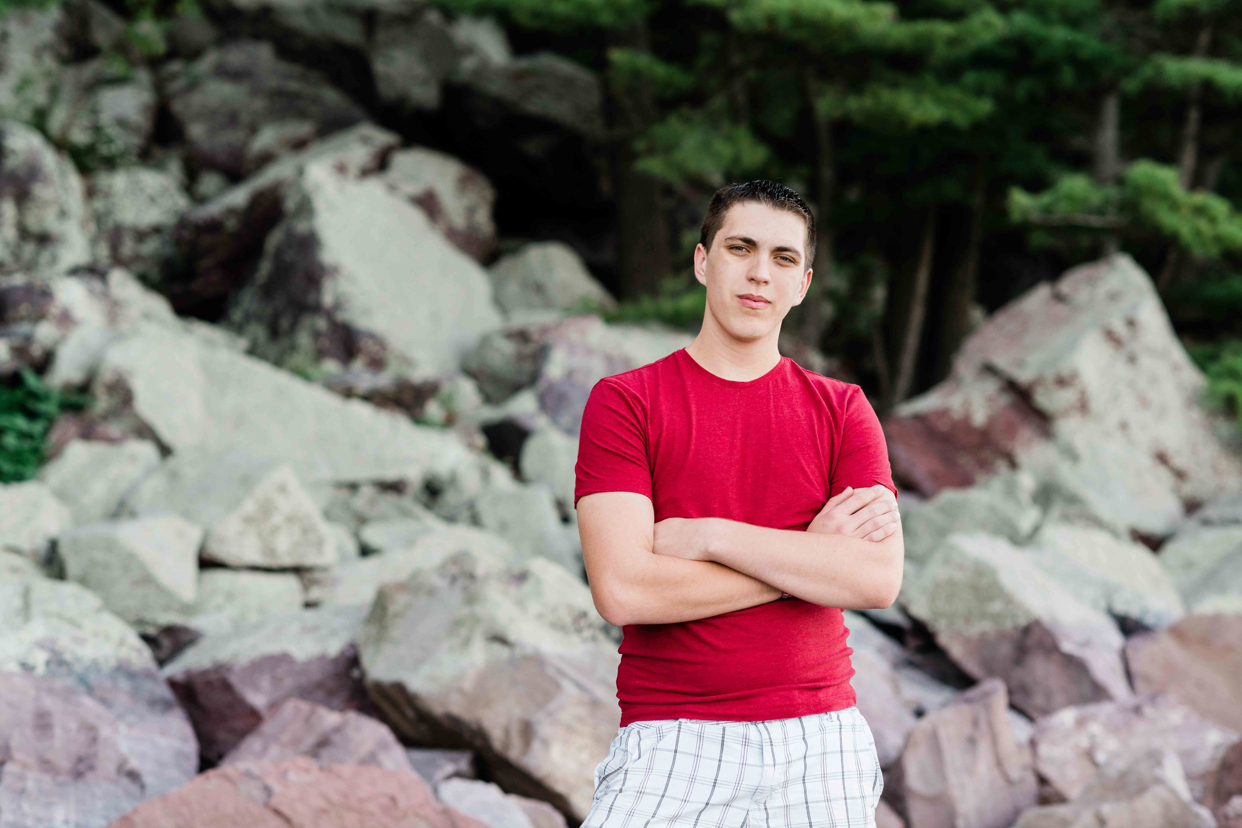 High school senior standing on the rocks at Devil's Lake State Park in Baraboo, Wisconsin