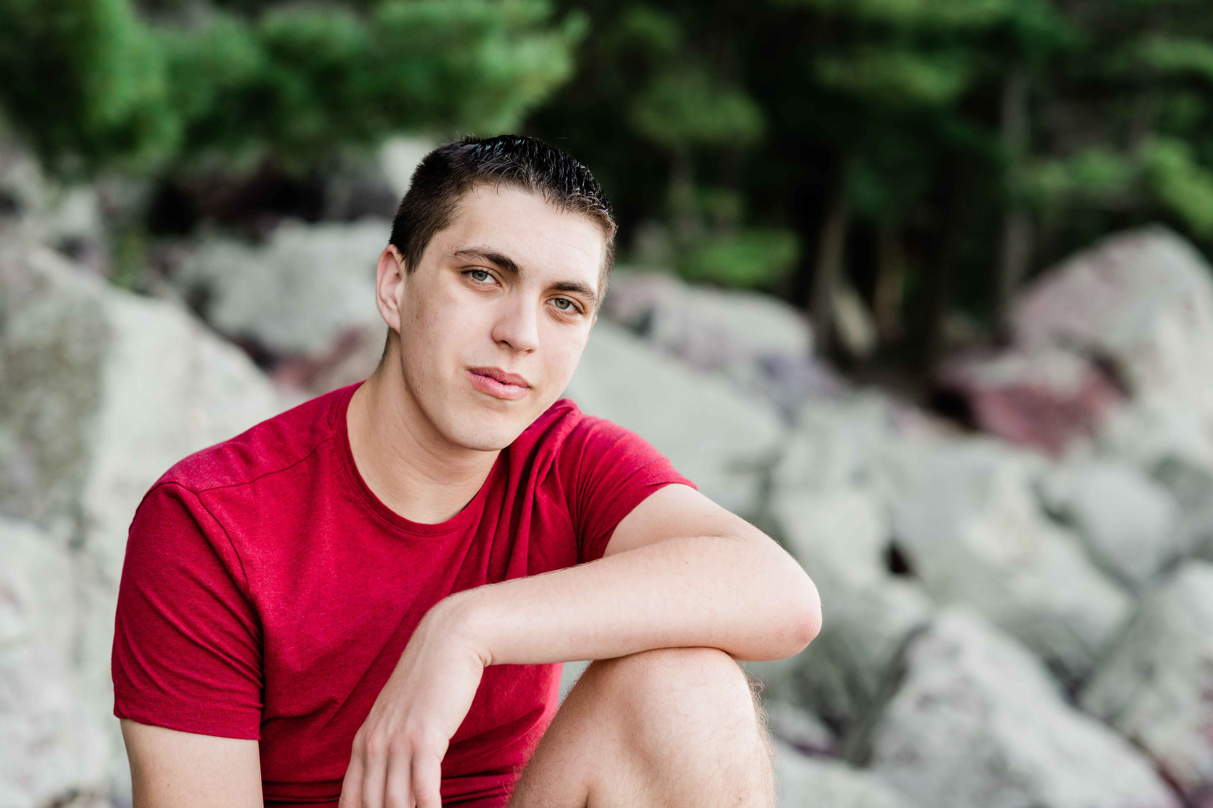 High school senior sitting on the rocks at Devil's Lake State Park in Baraboo, Wisconsin