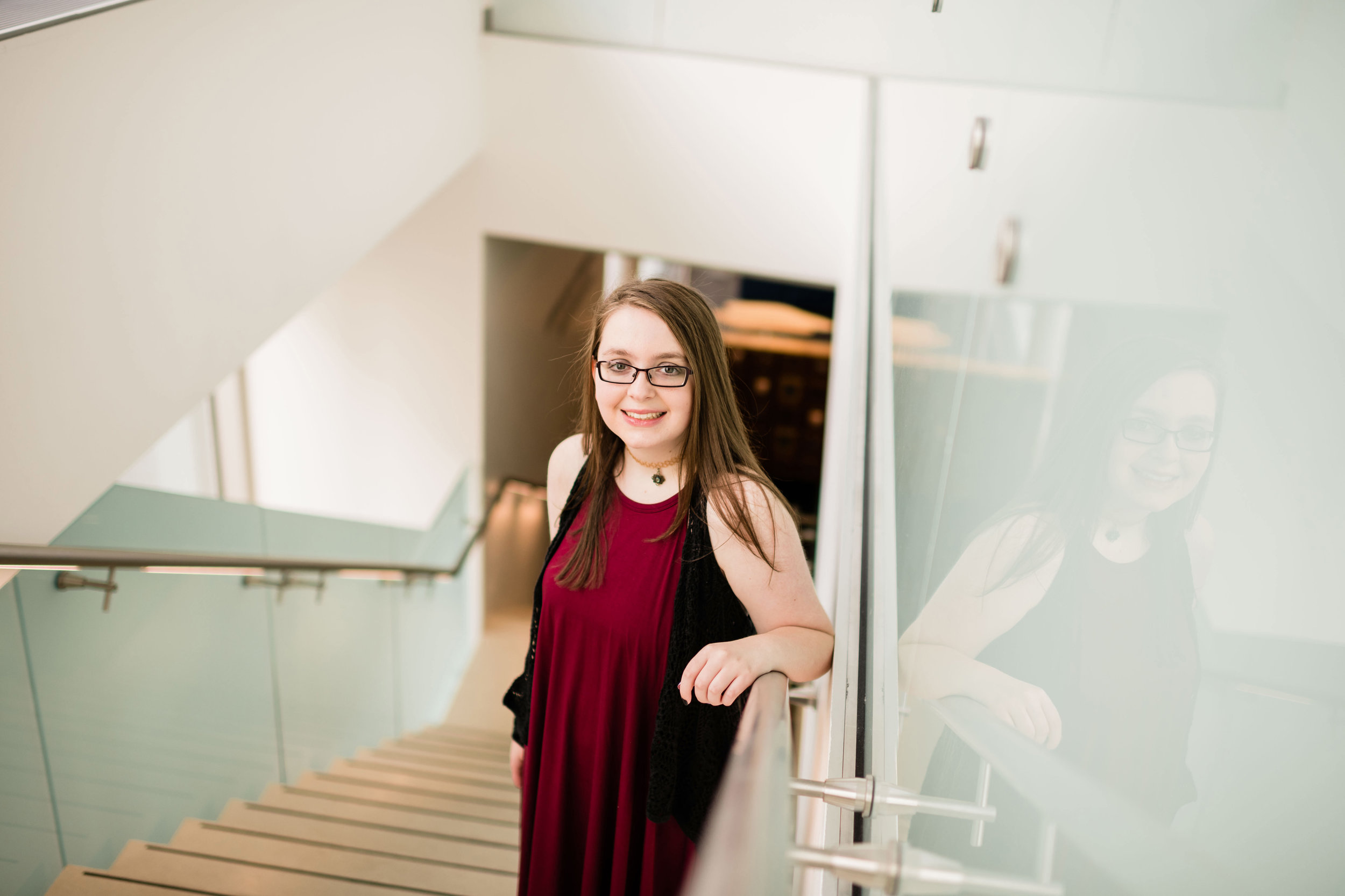 High school senior standing on the stairs at the Madison Public Library downtown