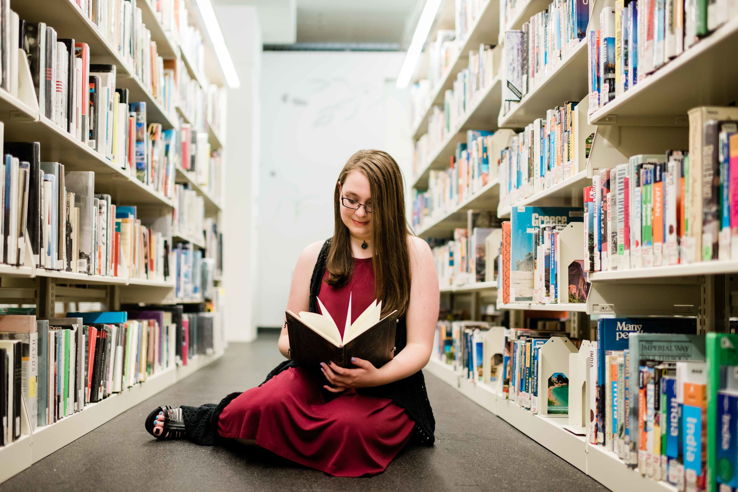 High school senior reading a book in the stacks at Madison Public Library