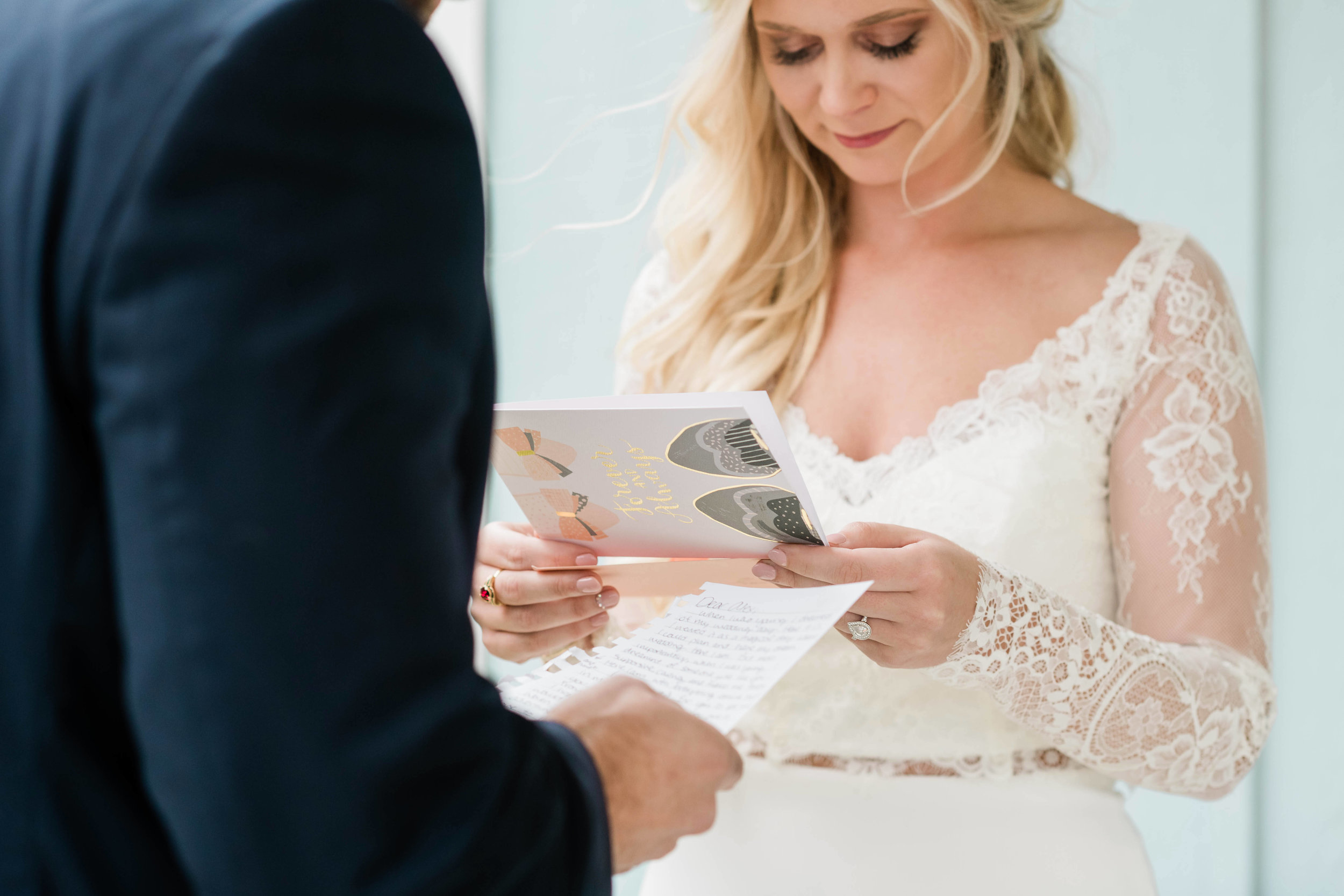 Bride and groom reading letters to each other