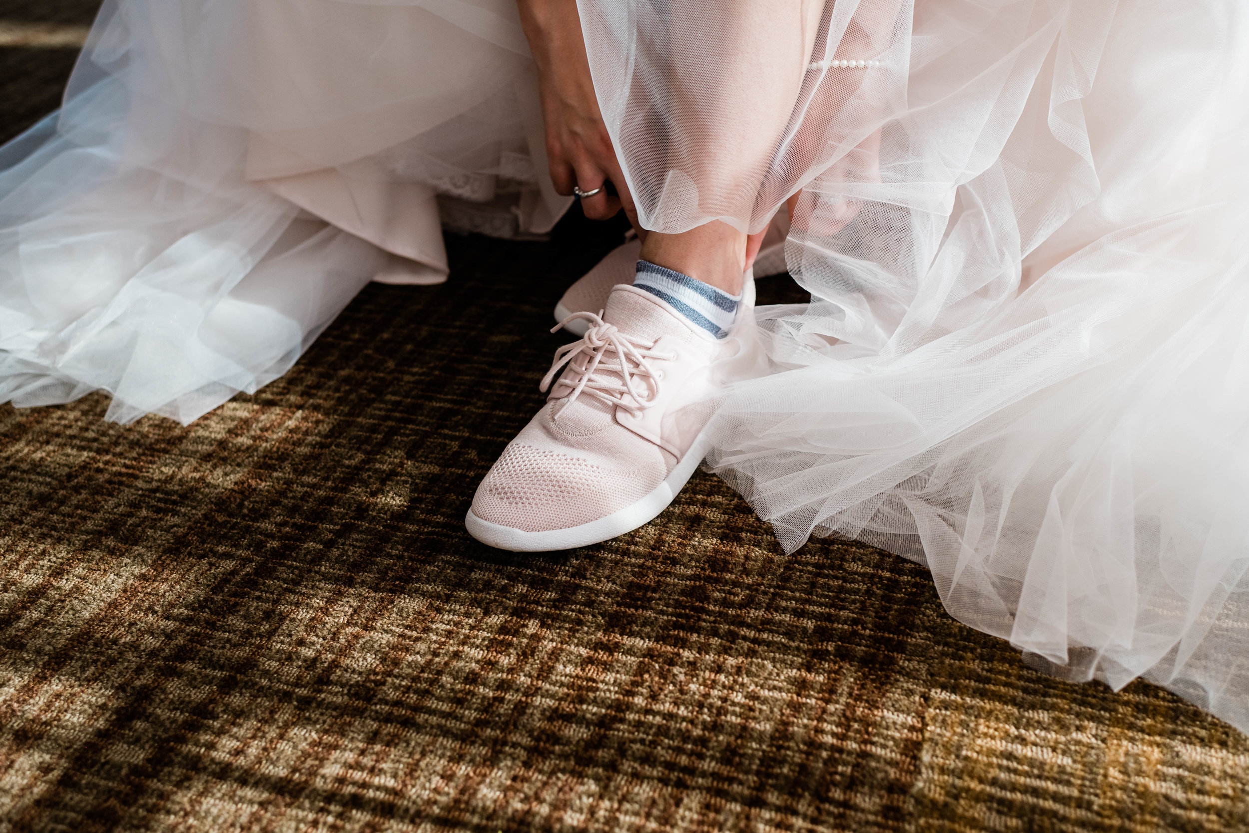 Bride putting on her tennis shoes