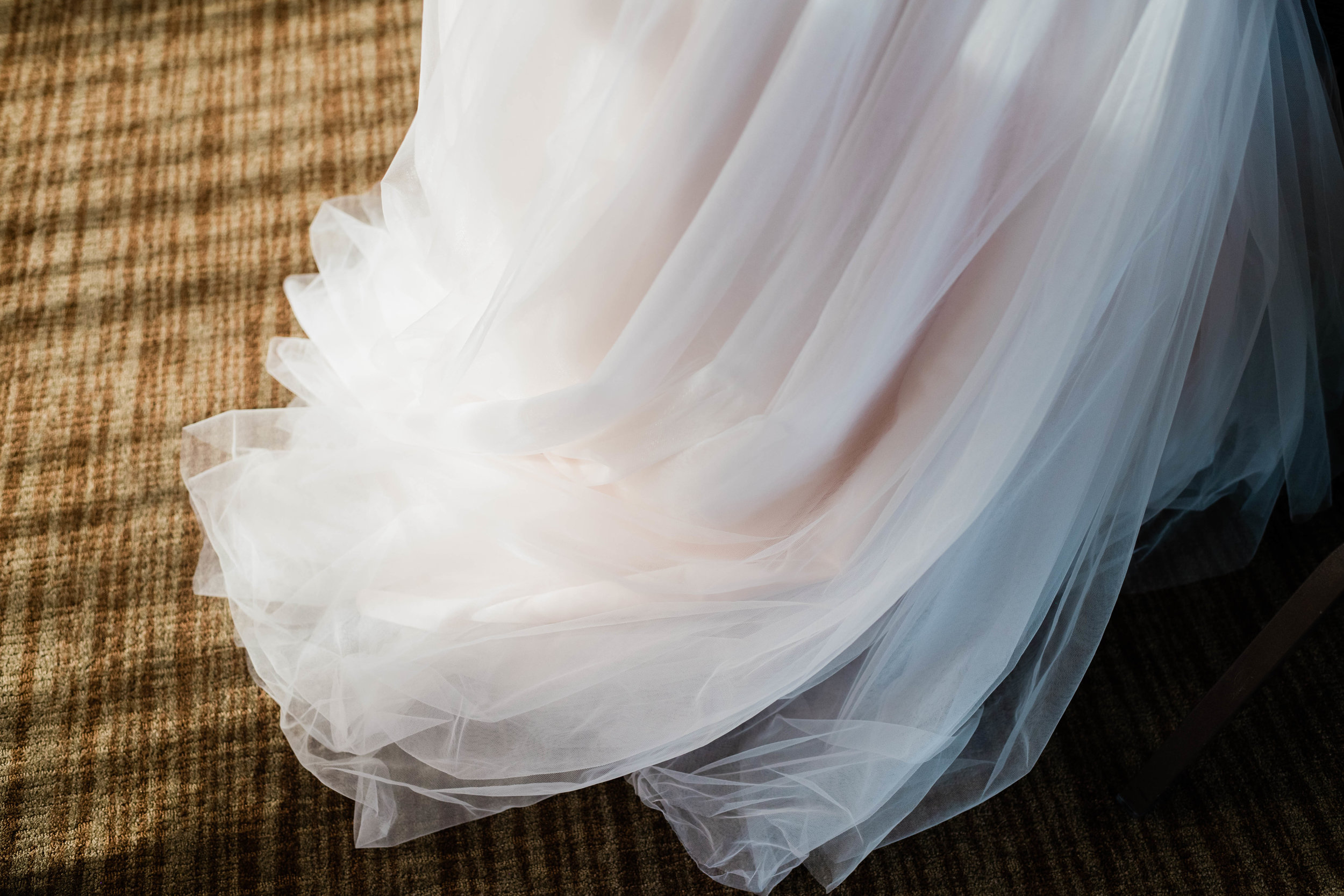 Sunlight shines on the bottom of a wedding dress