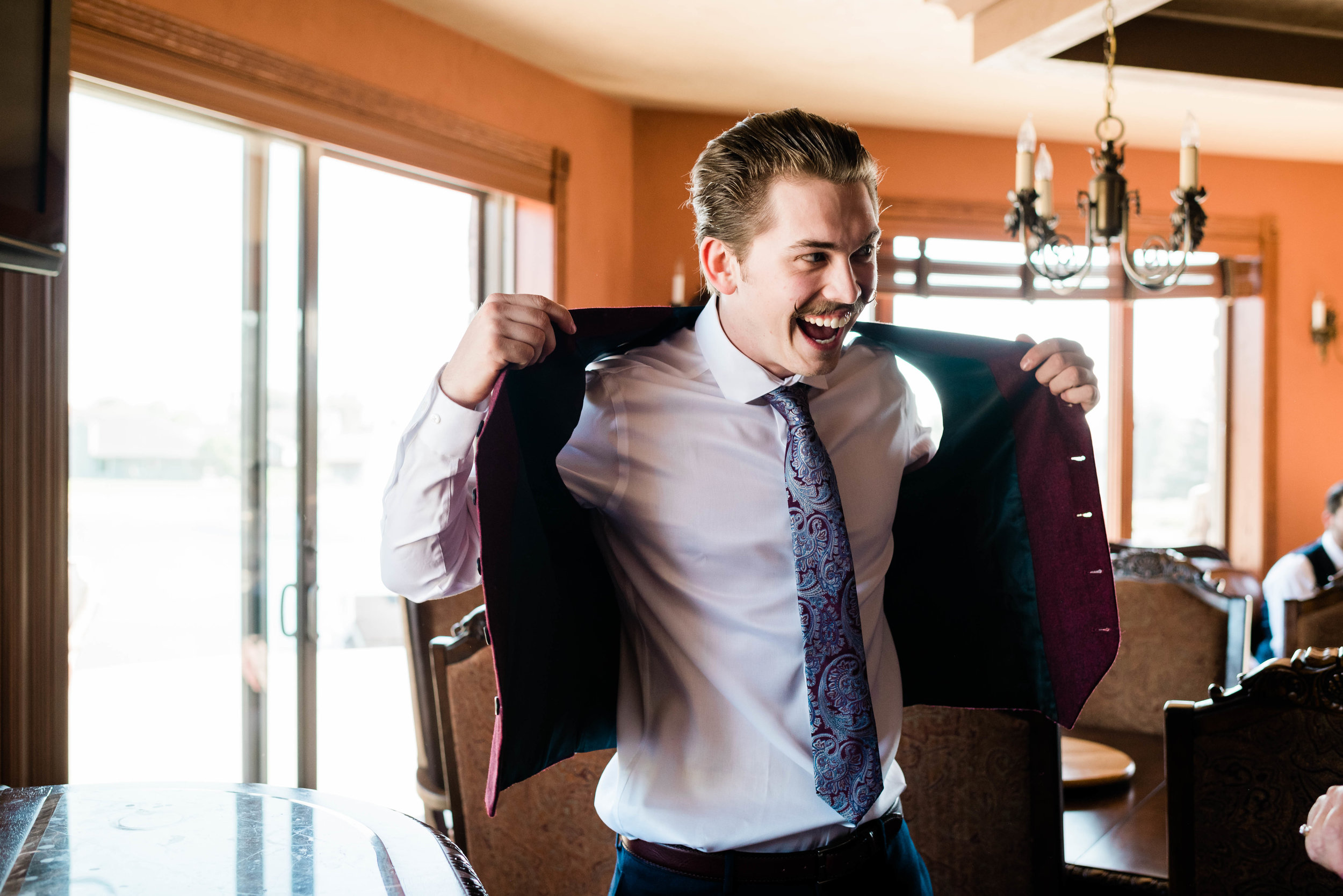 Groom putting on his vest