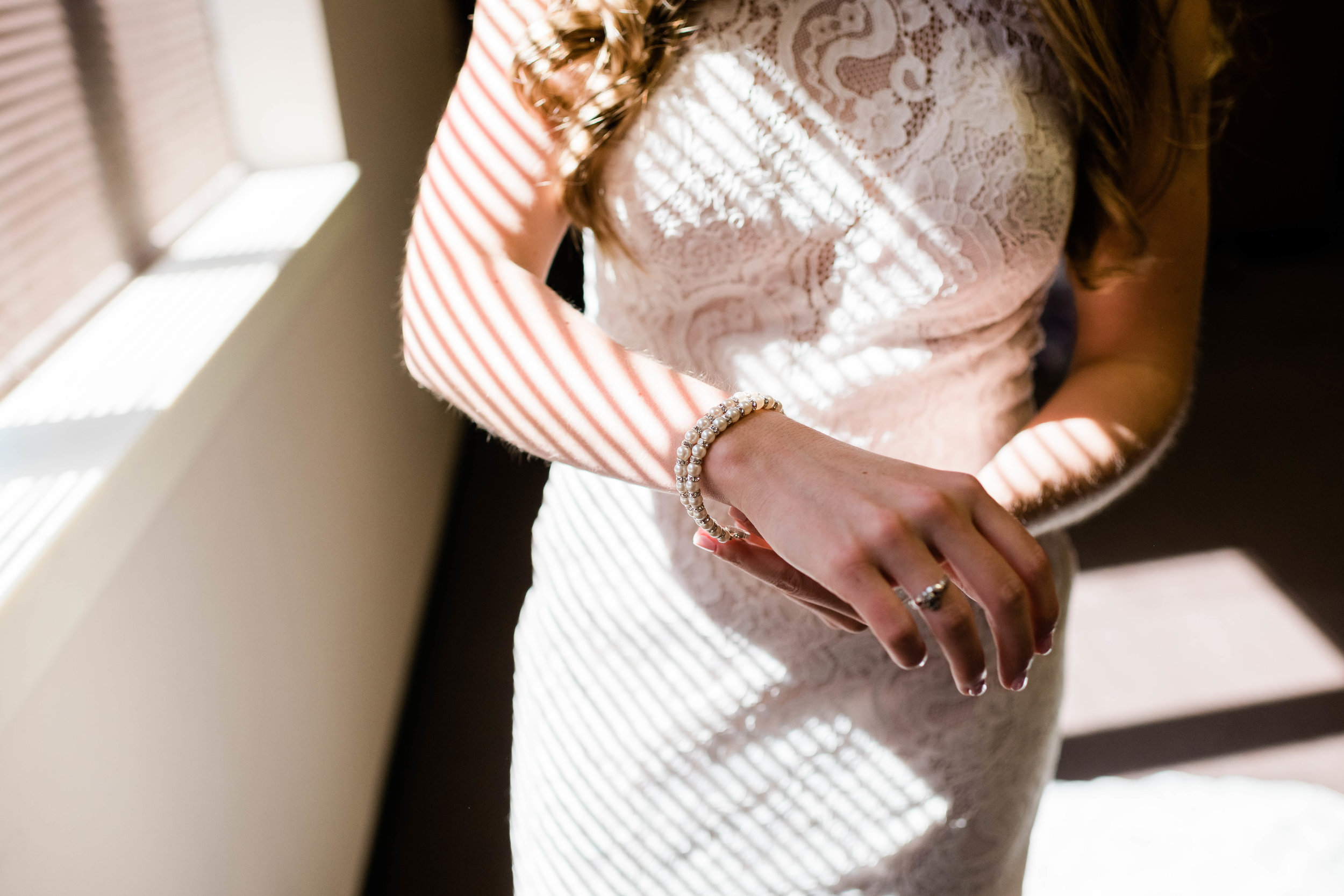 Bride putting on her bracelet