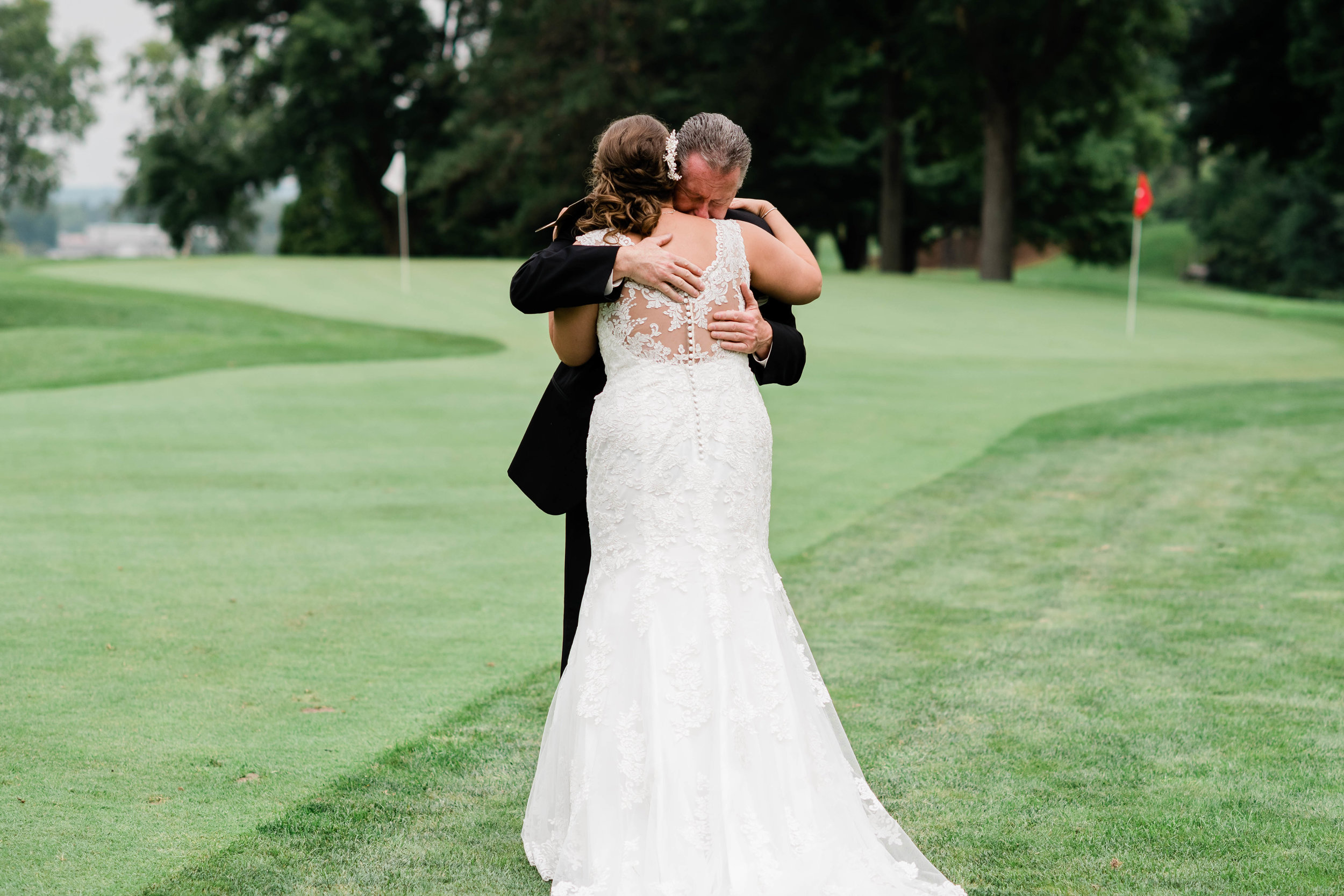 Dad hugs his daughter on her wedding day