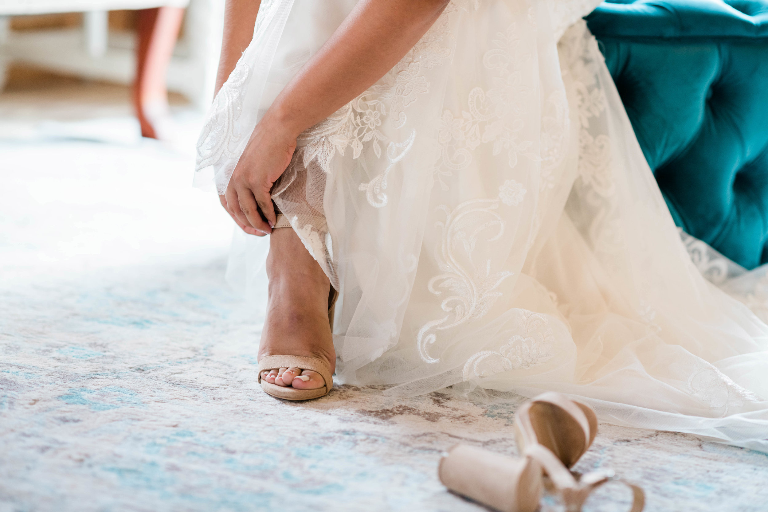 Bride fastening her shoe strap