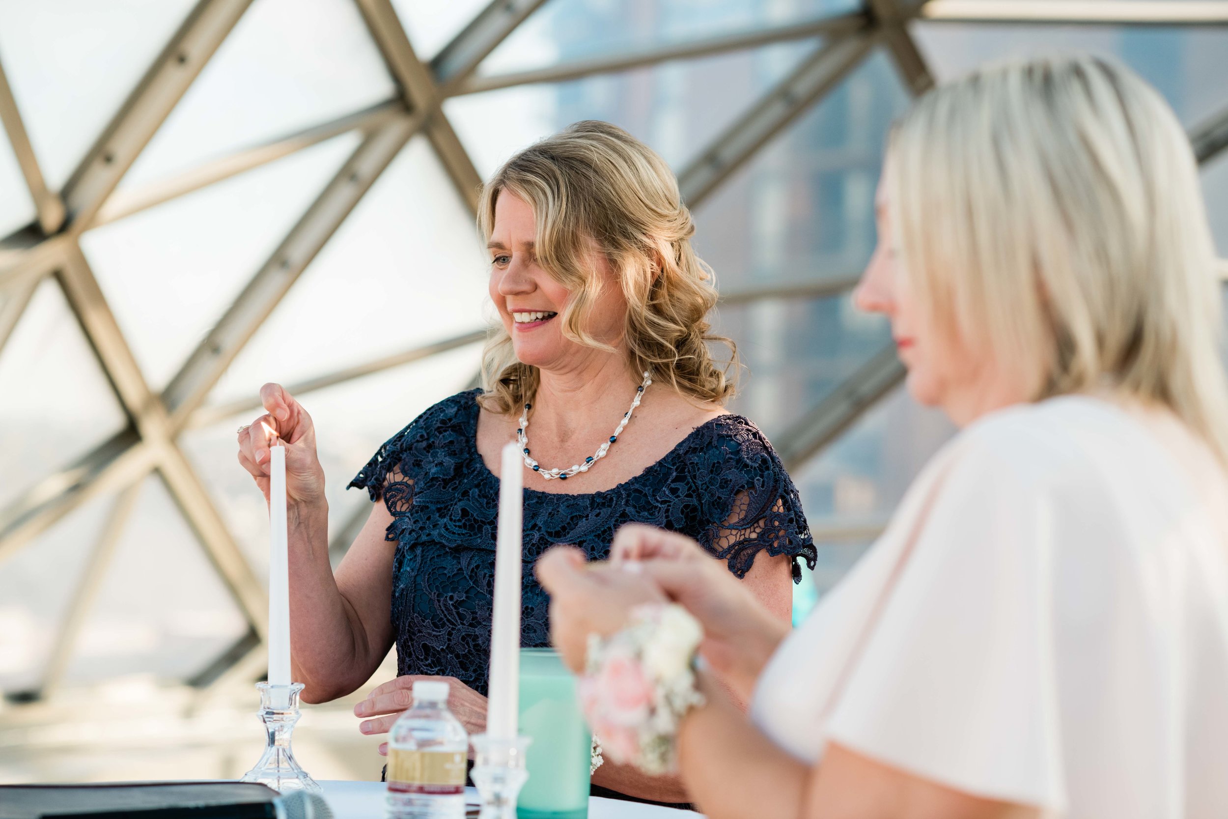 Mothers light candles before wedding ceremony