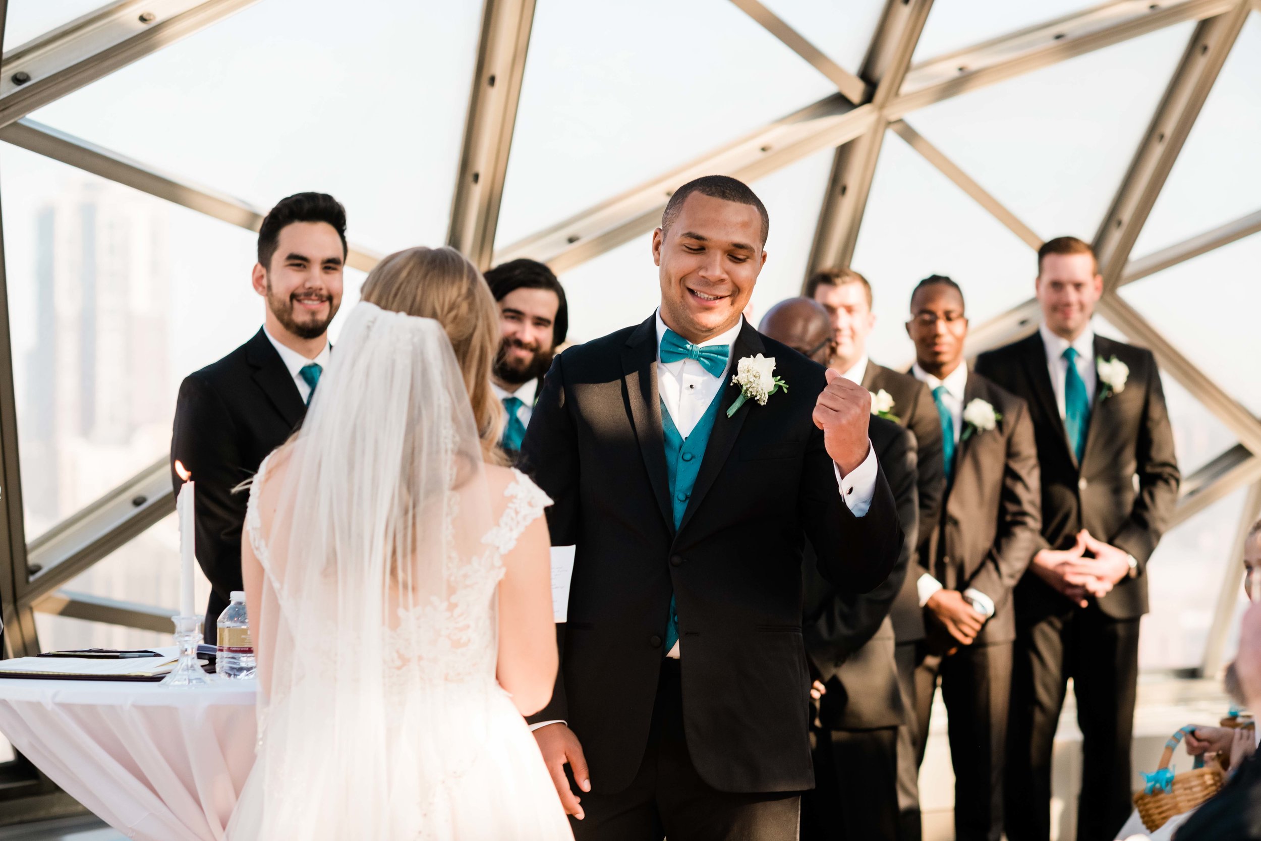 Groom does a fist pump during the ceremony