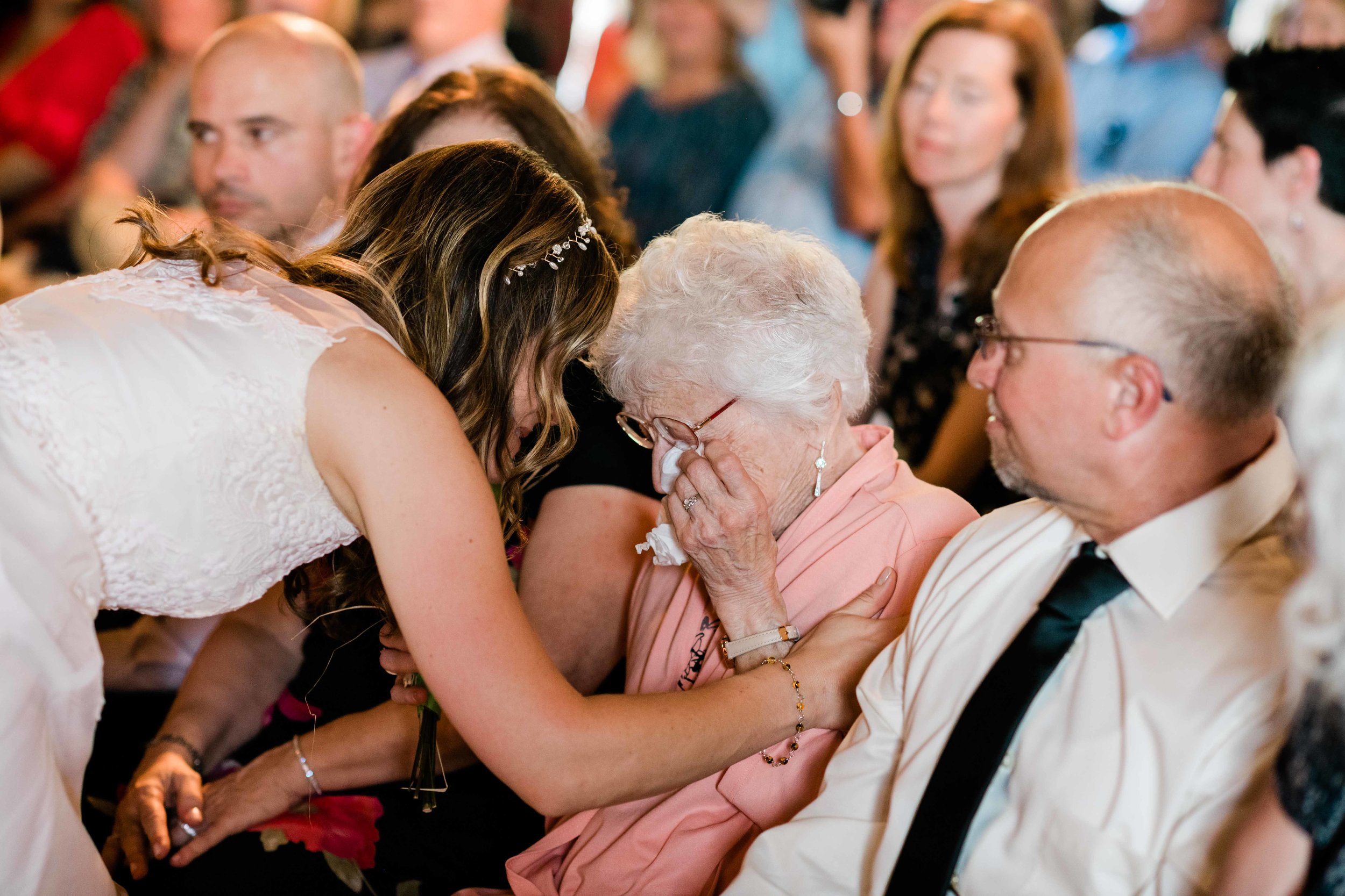 Bride comforting her grandma as she cries