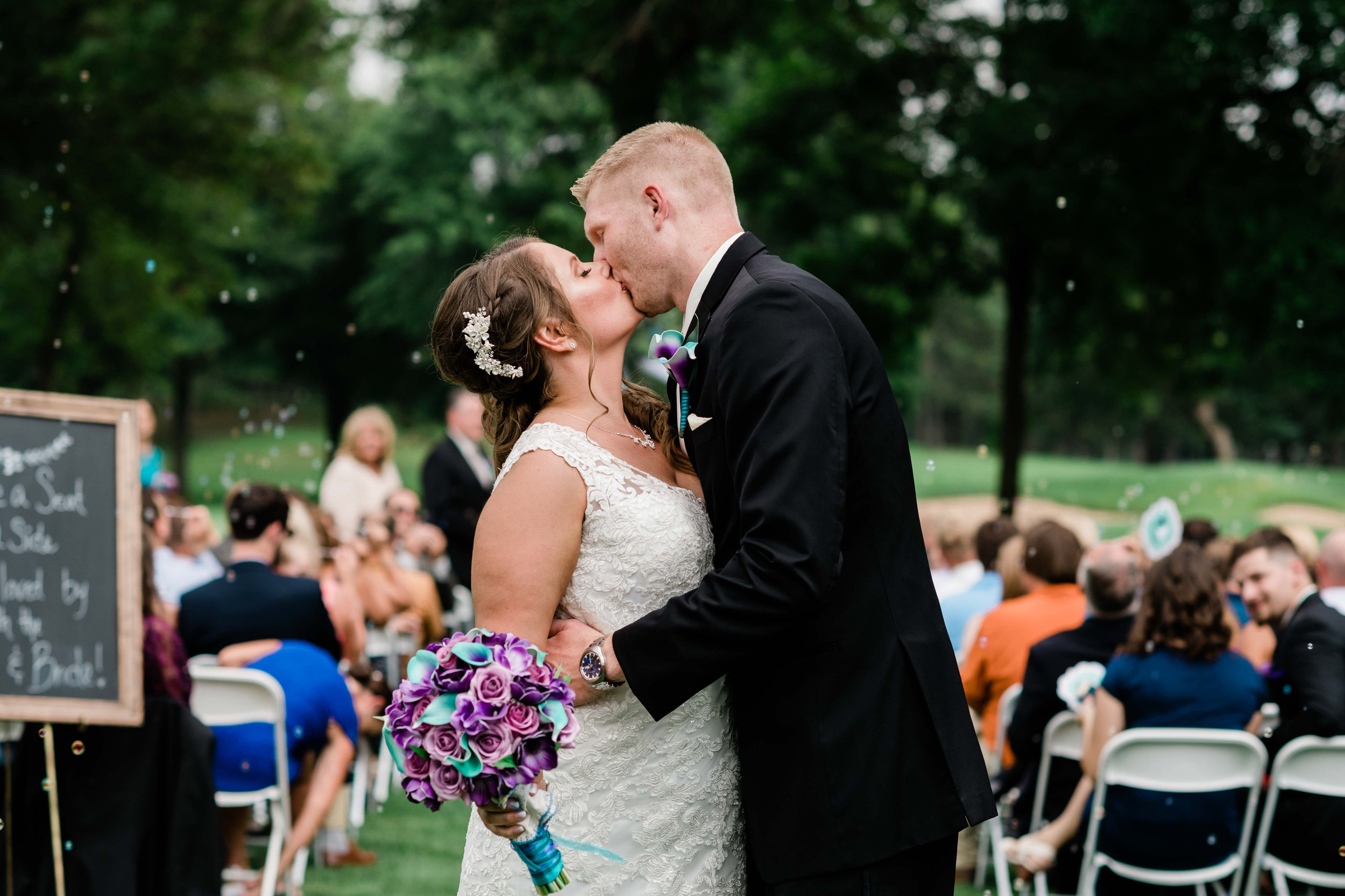 Bride and groom kiss after their wedding ceremony