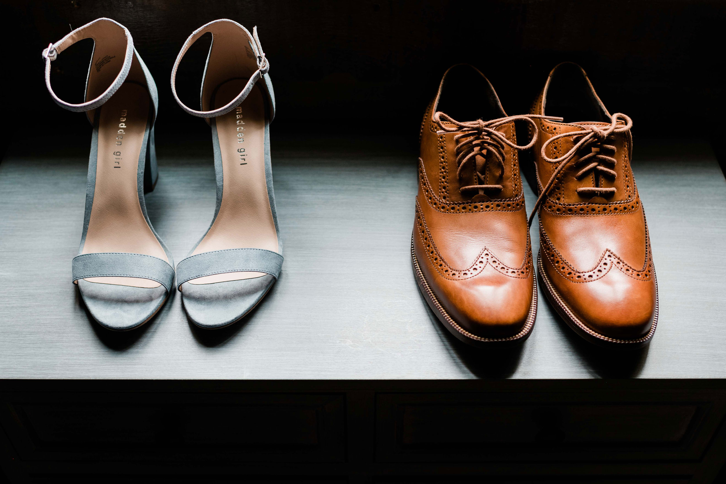 Bride and groom shoes on dresser