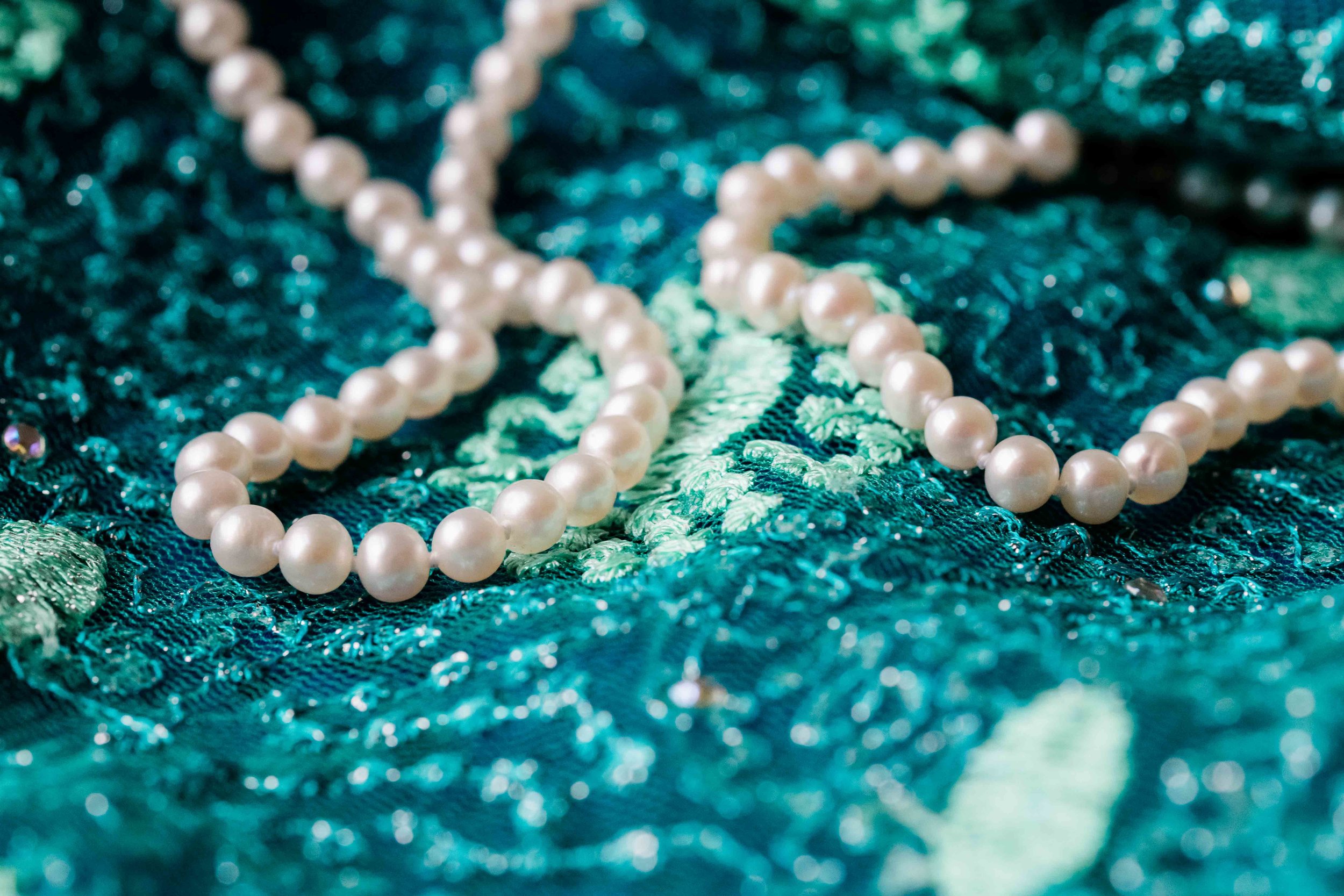 Pearls on teal dress