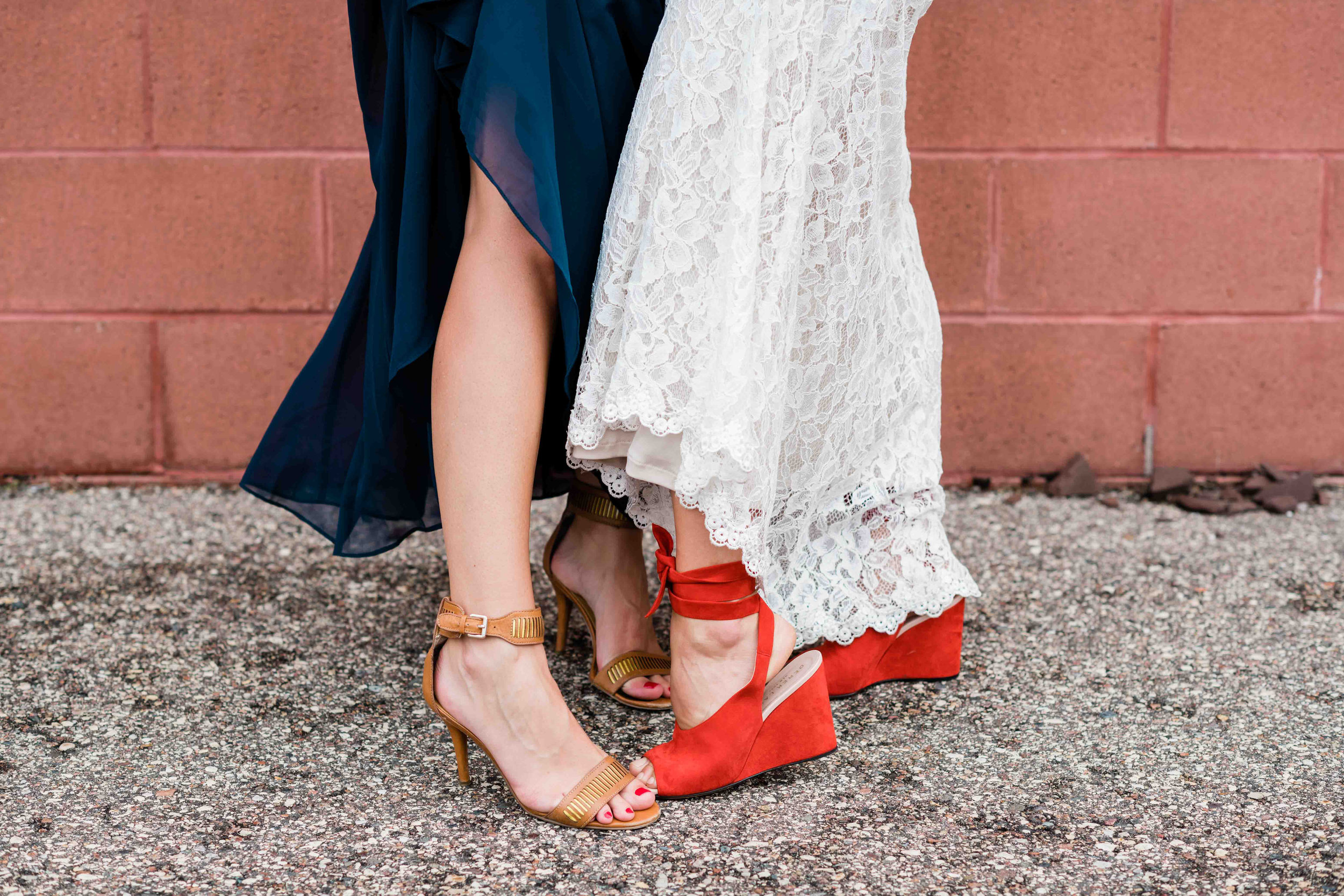 Bride and bridesmaid show off their shoes