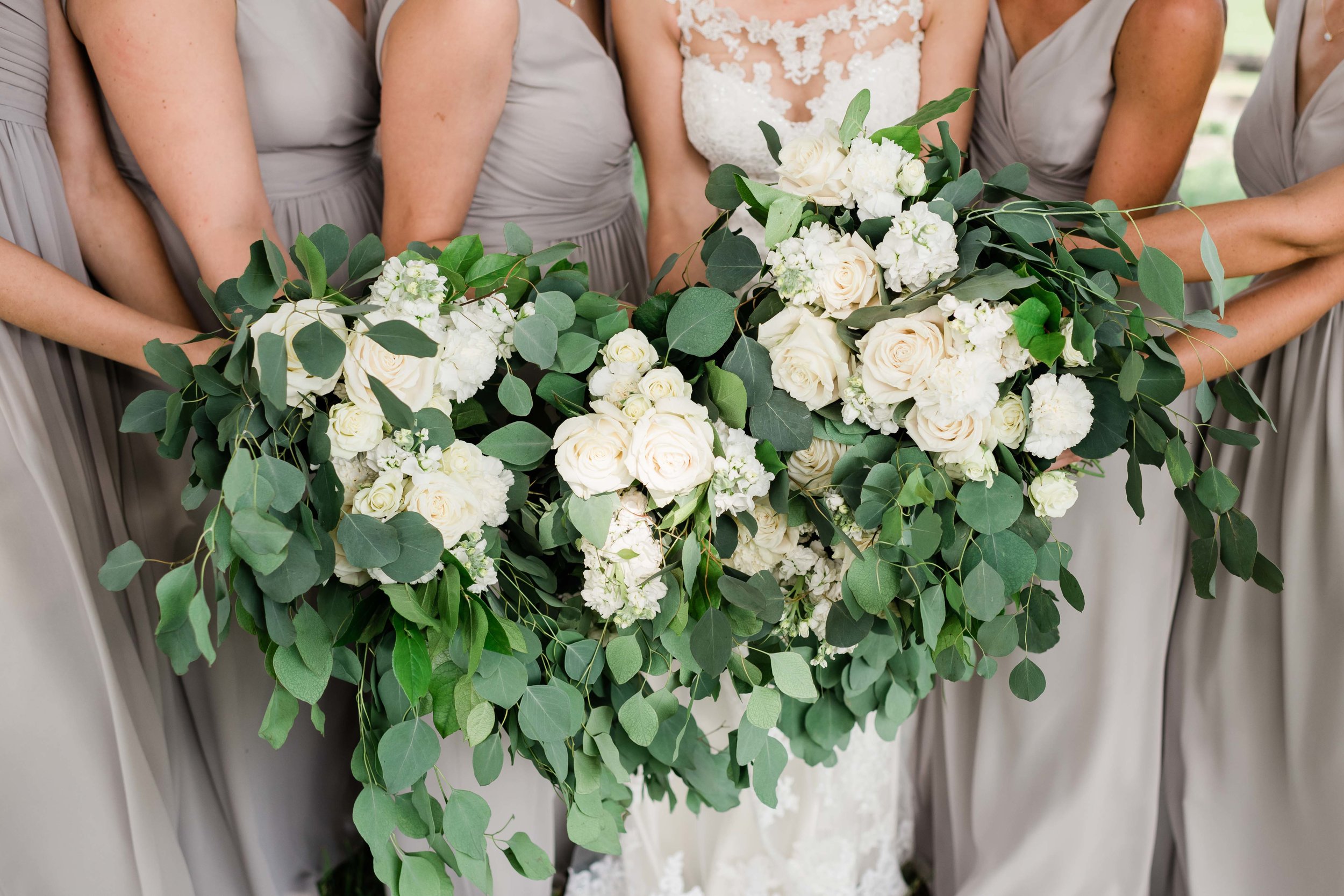 Wedding party holds their bouquets