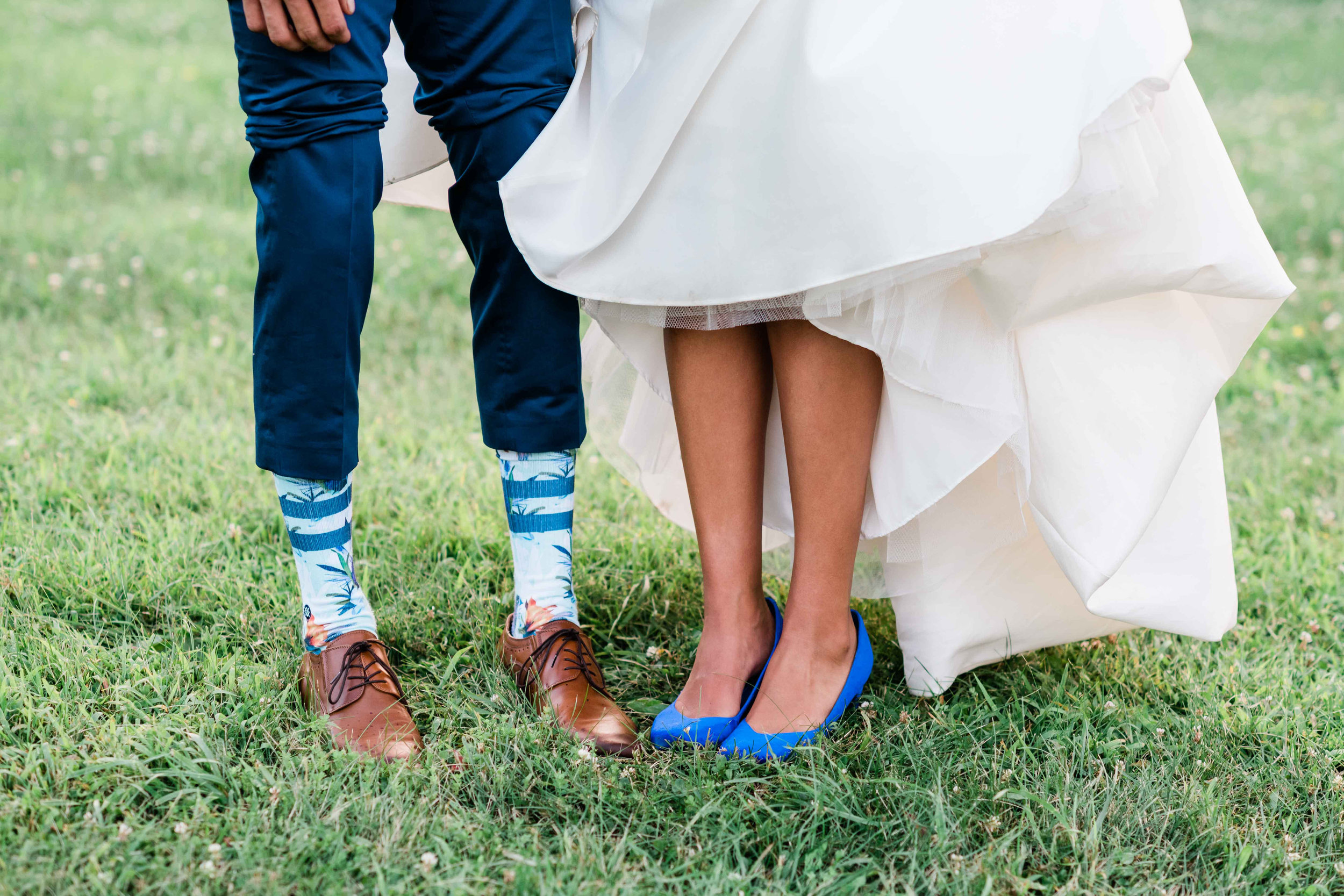 Bride and groom showing their footwear