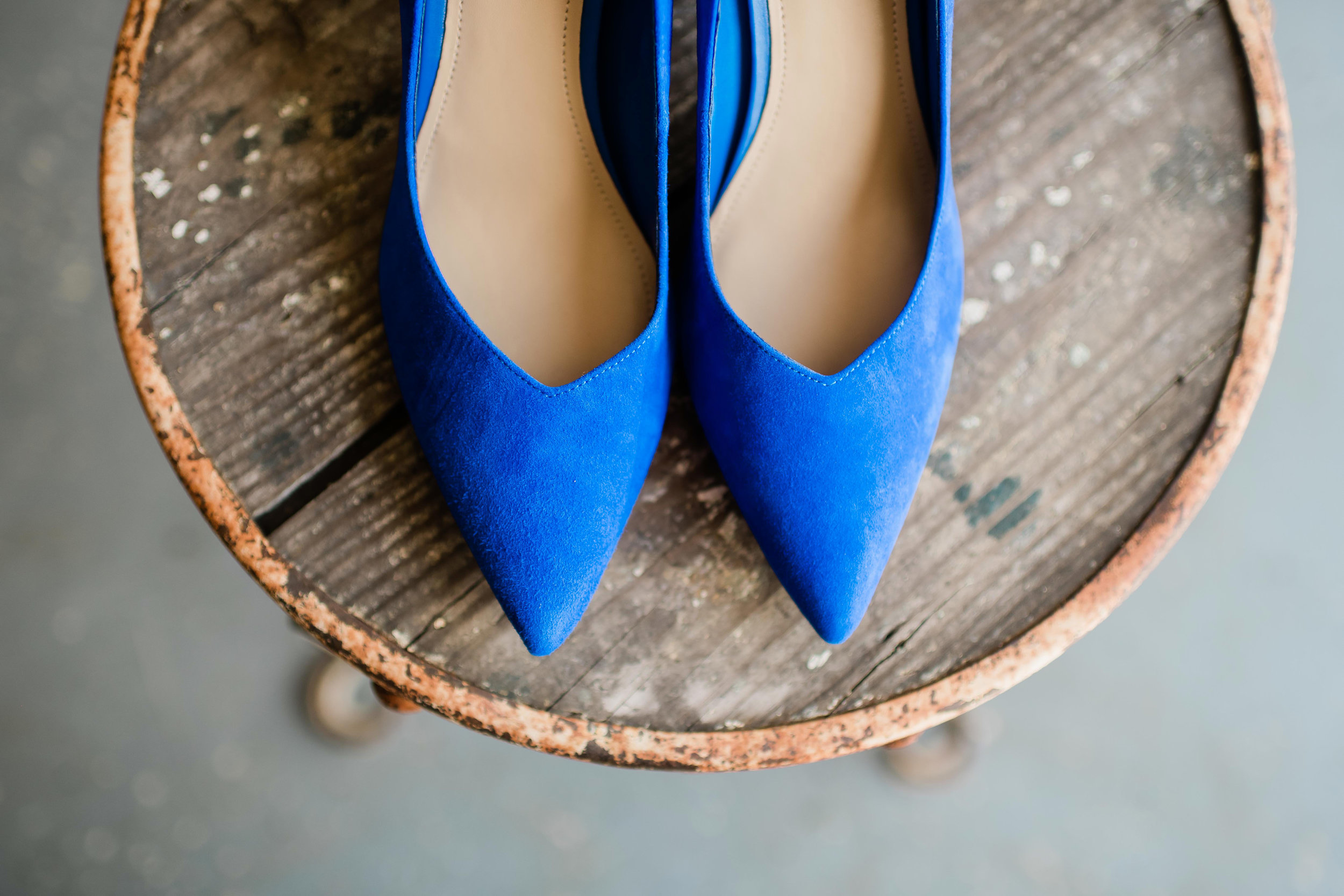 Blue bridal shoes sitting on rusty chair