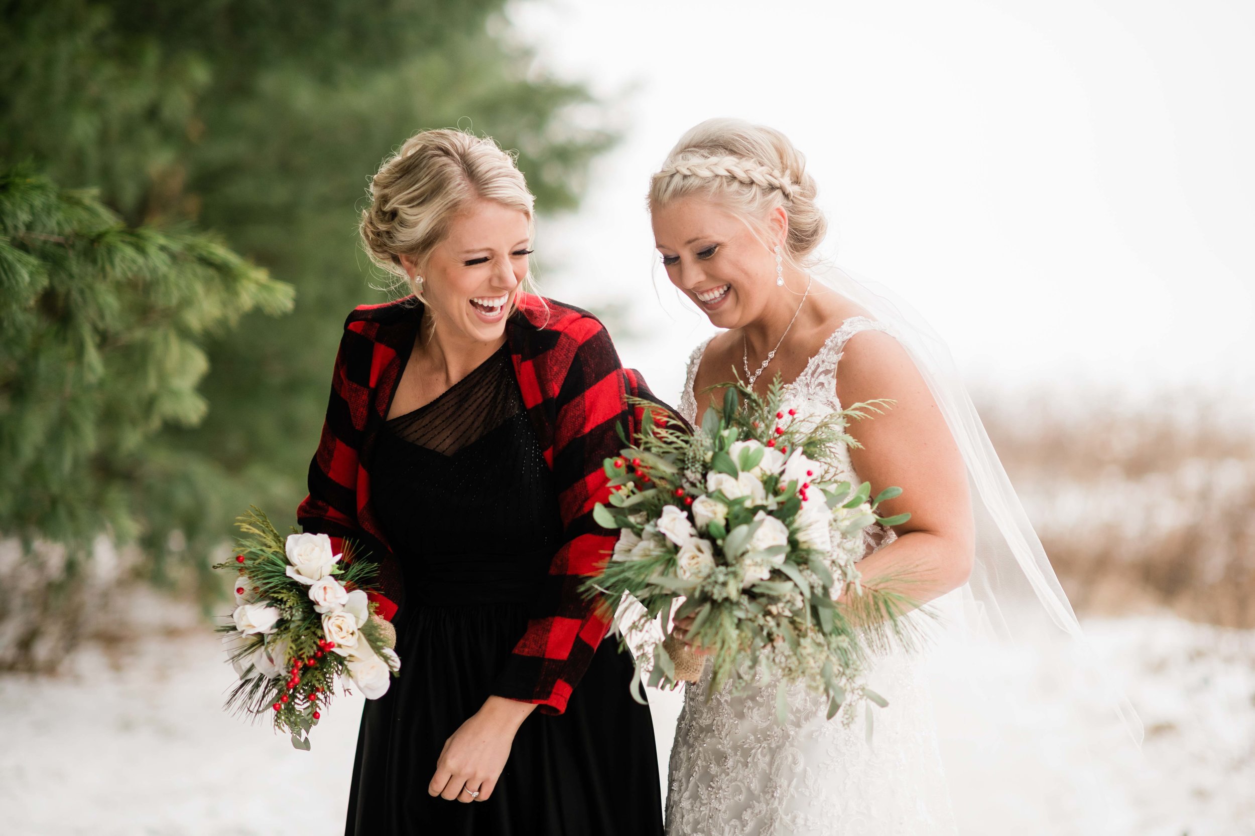Bride and bridesmaid laughing
