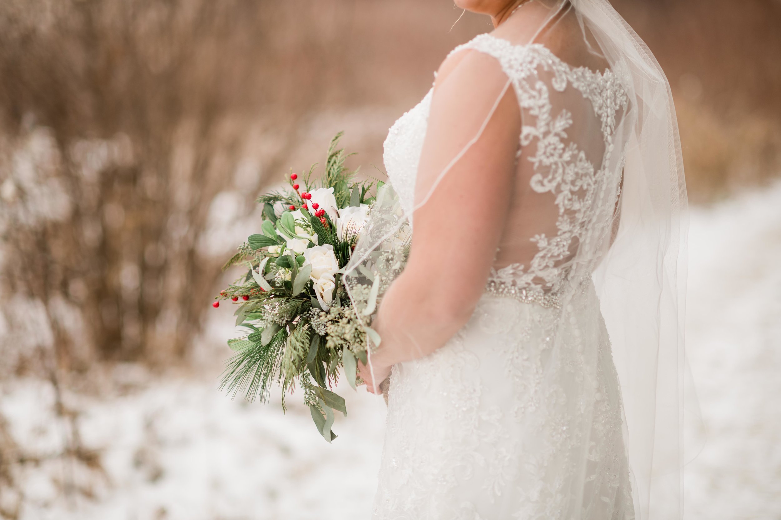 Bride holding her bouquet outside in winter