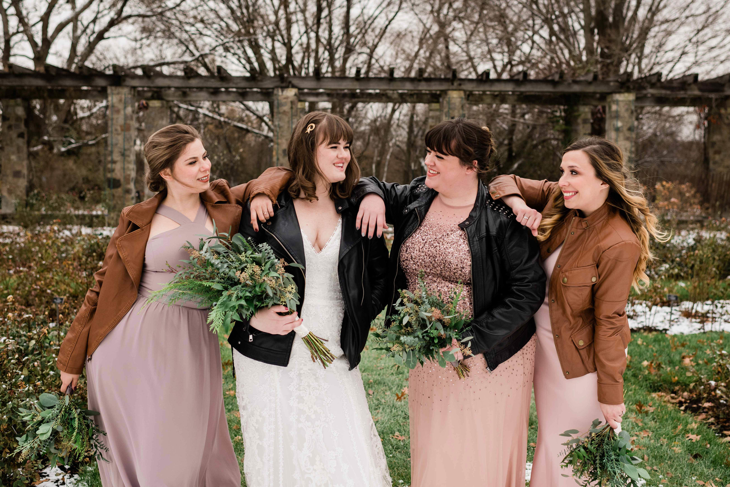 Bride and bridesmaids casually laughing with each other