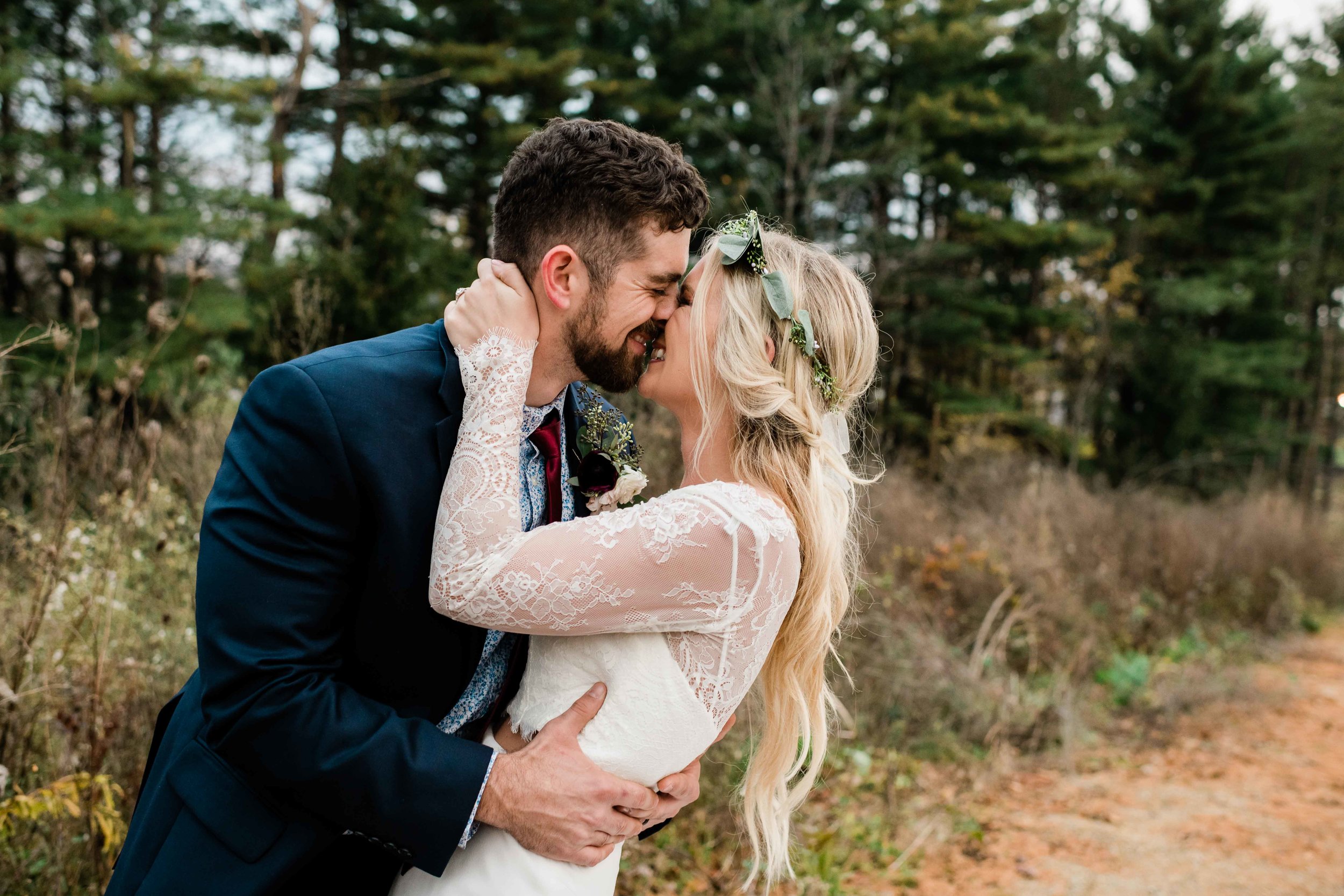 Bride and groom smile as they're about to kiss