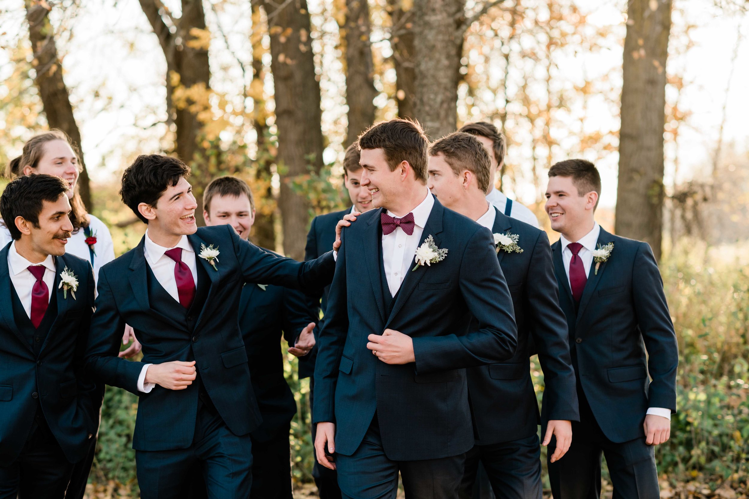 Groom and his groomsmen walking and laughing