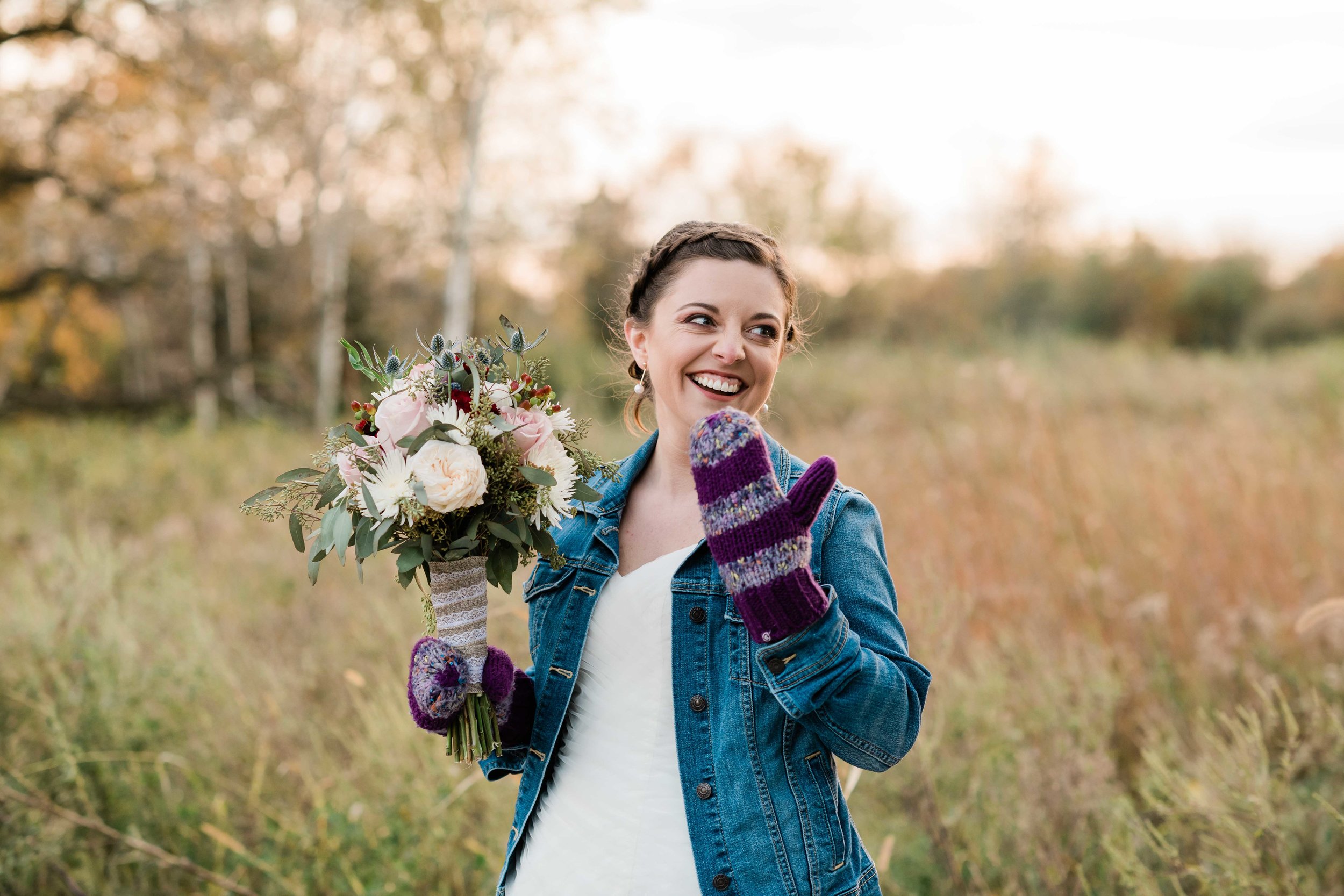 Bride wearing mittens and laughing