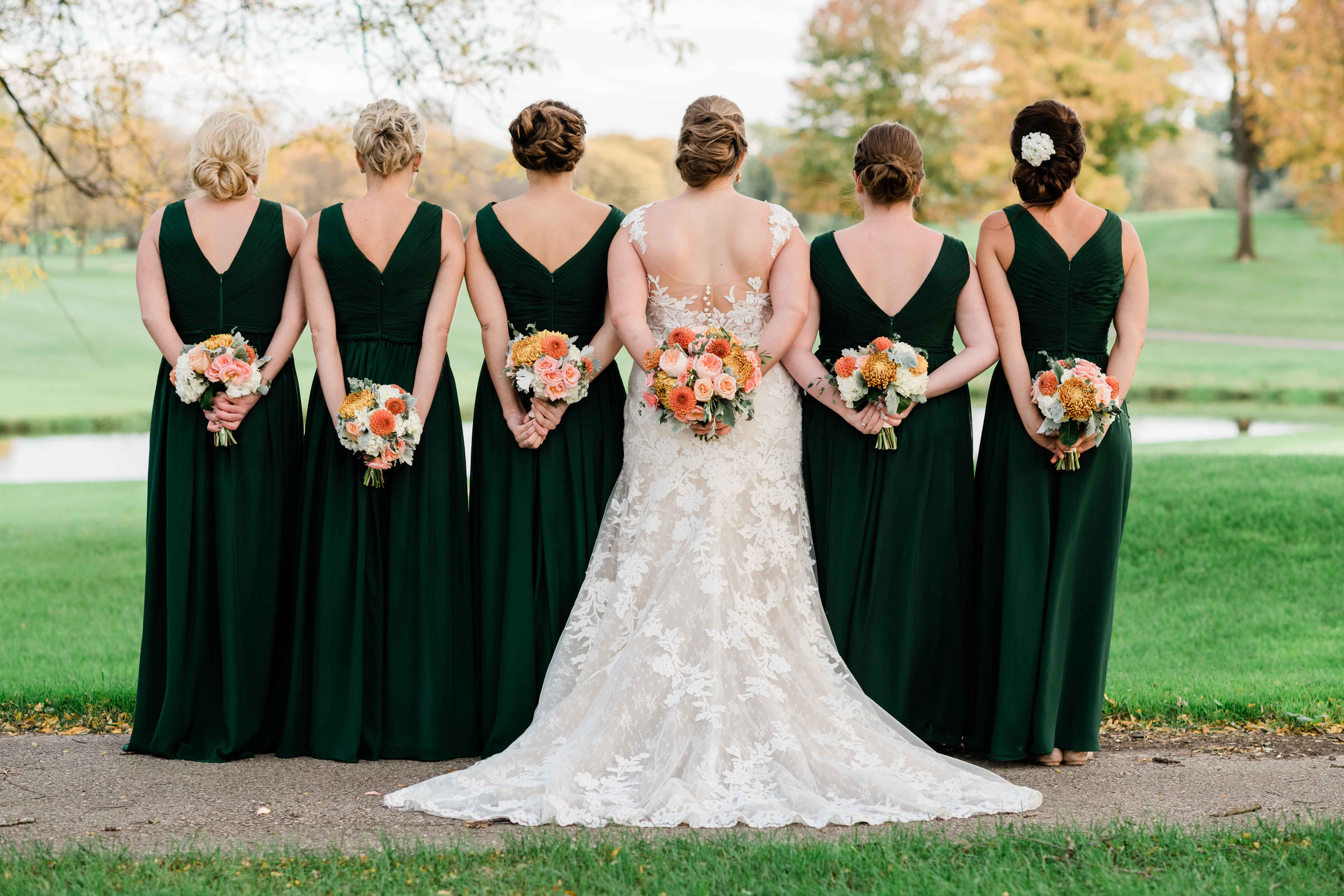 Bridesmaids holding their bouquets behind them