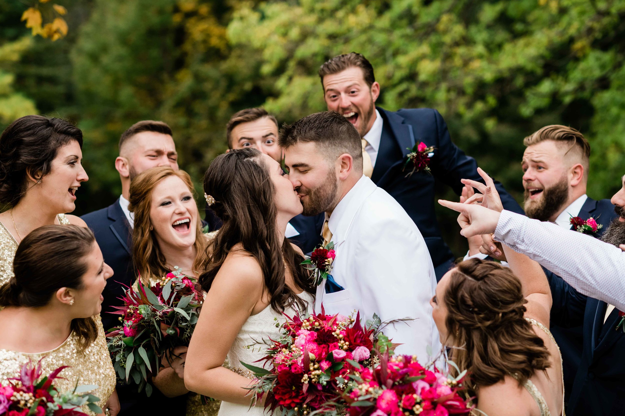 Wedding party cheering for bride and groom