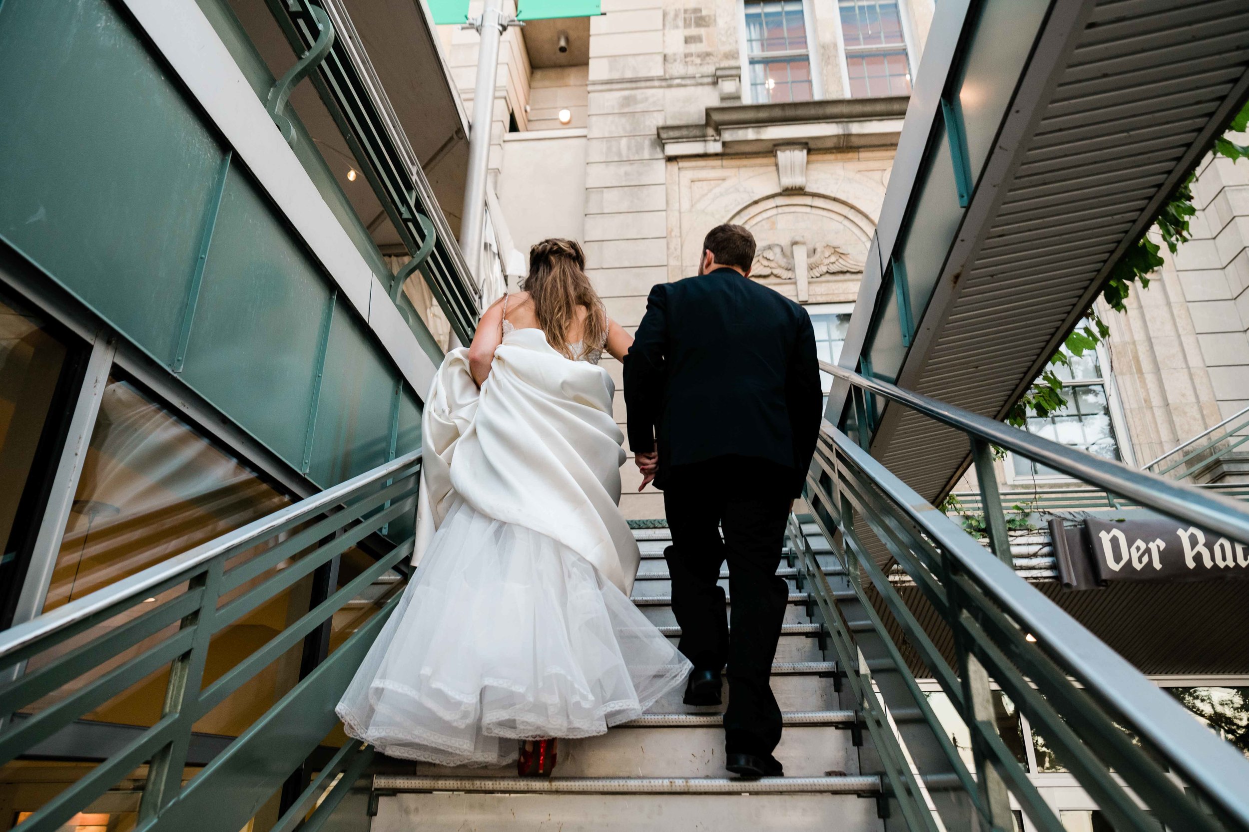 Bride and groom walking up stairs