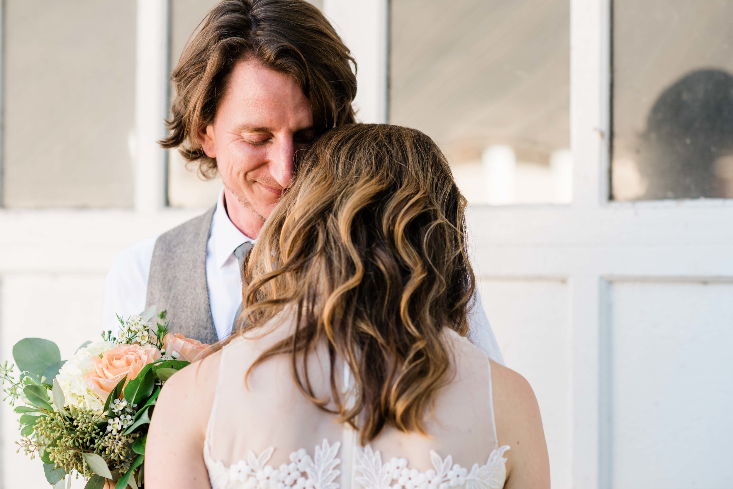 Groom smells bride's hair