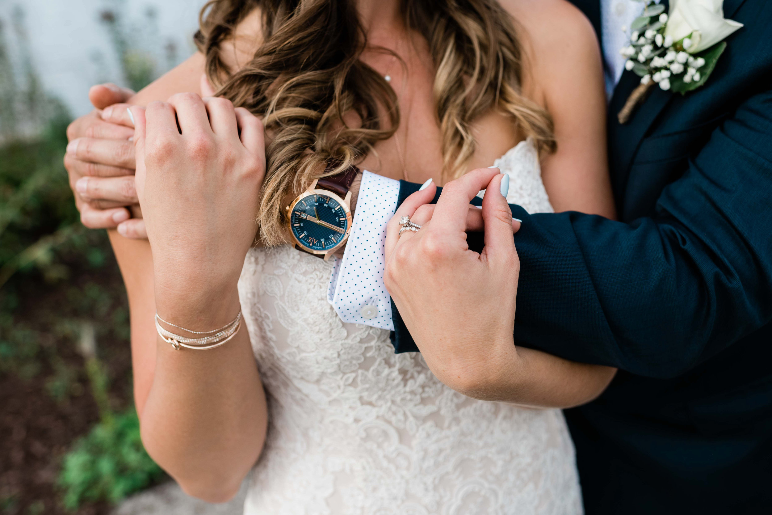 Groom holding bride from behind