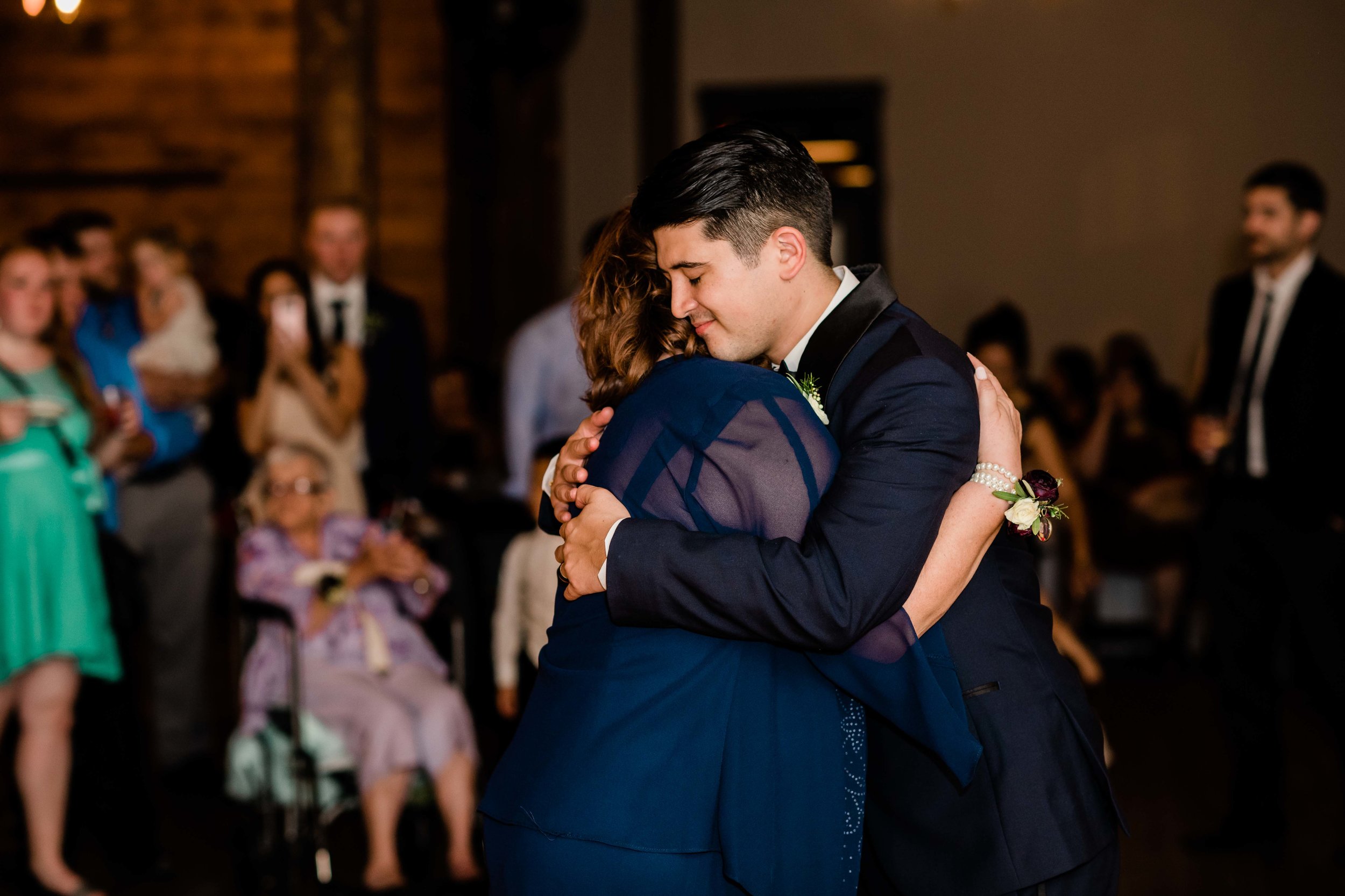 Groom hugs mom