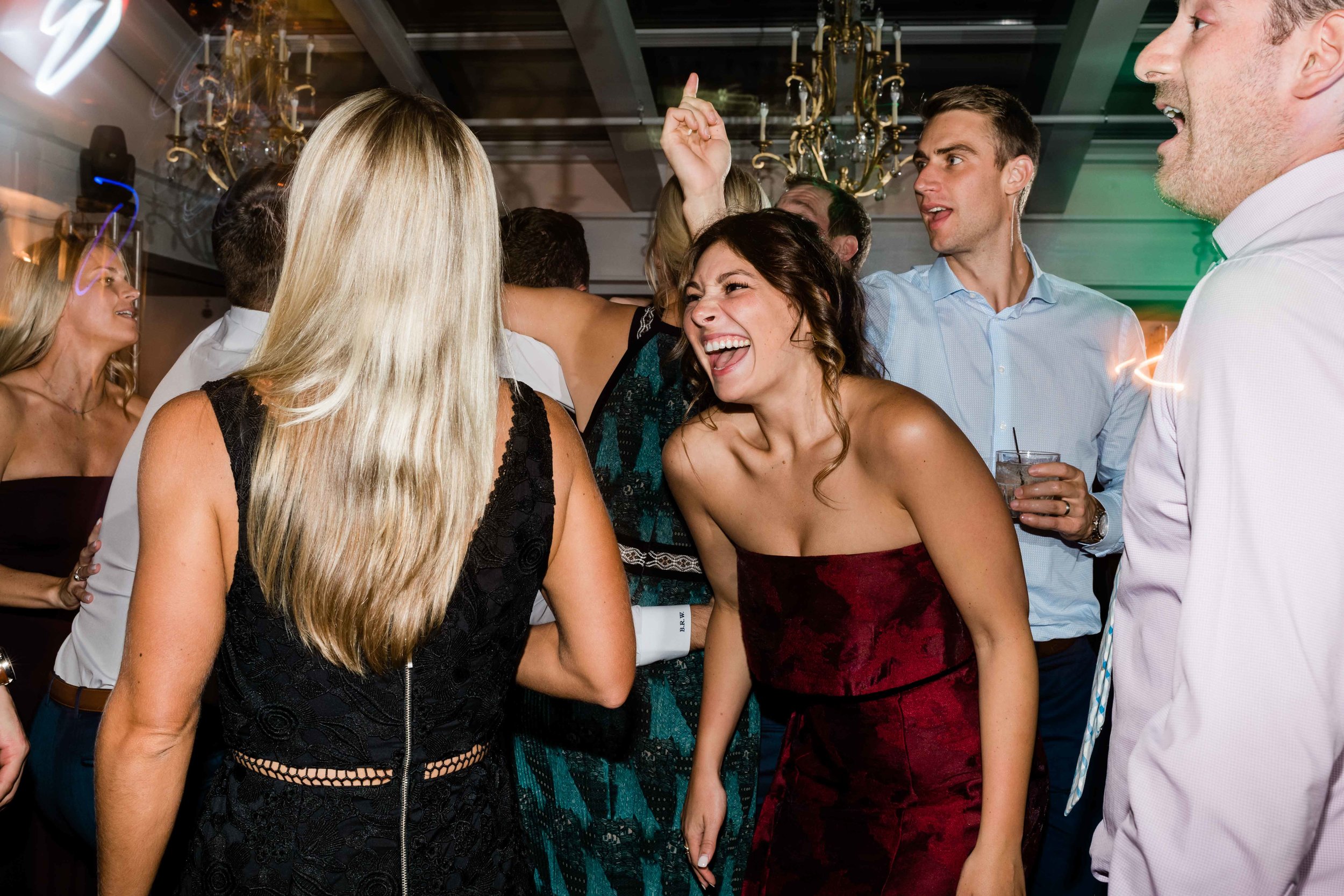 Wedding guests laughing on the dance floor
