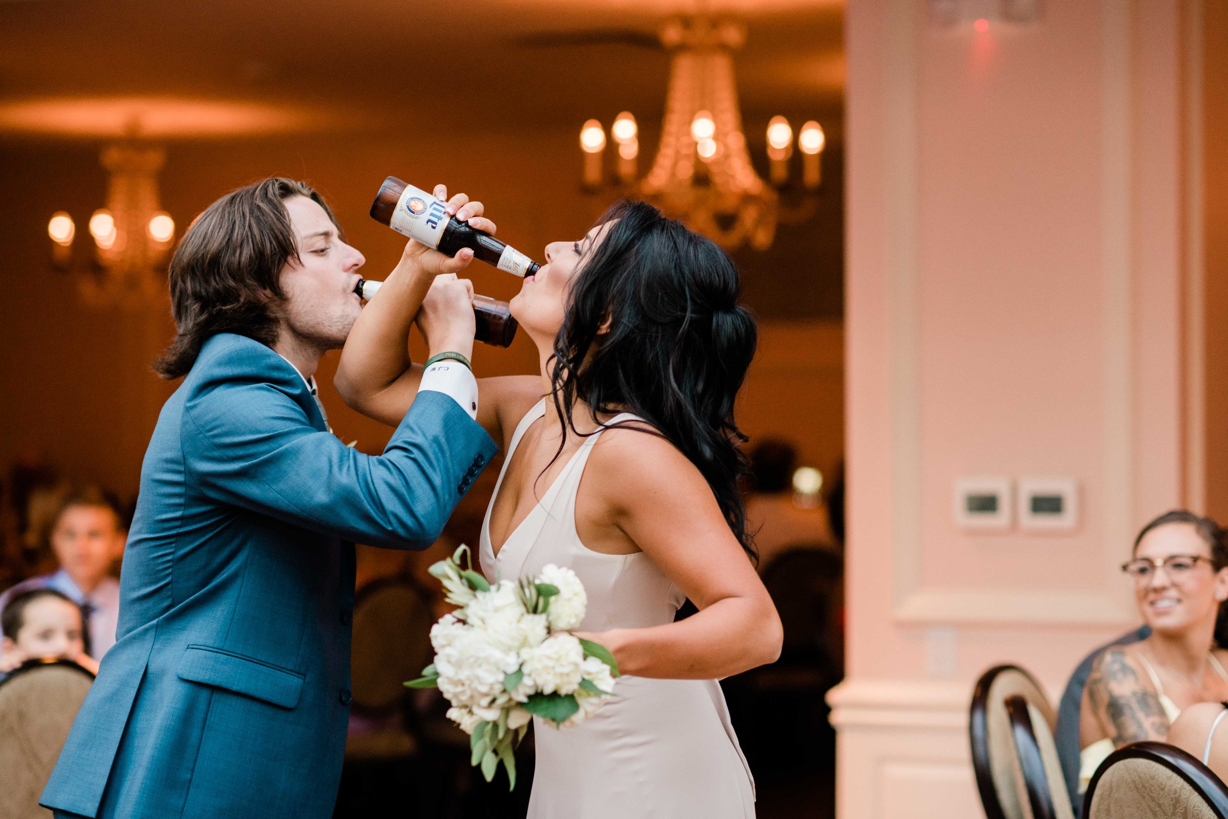 Groomsmen and bridesmaid chug beer during grand entrance