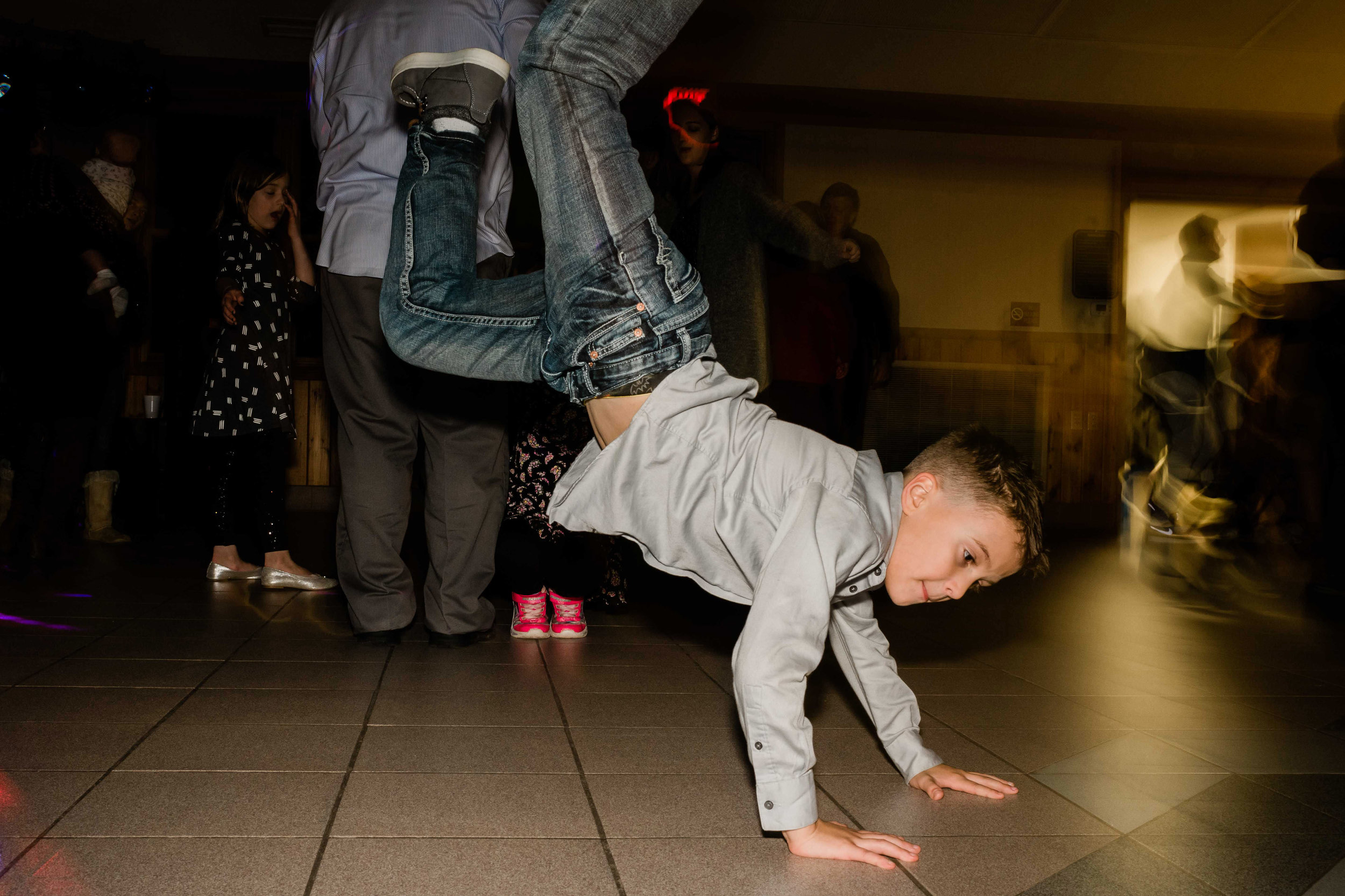 Wedding guest does handstand on the dance floor