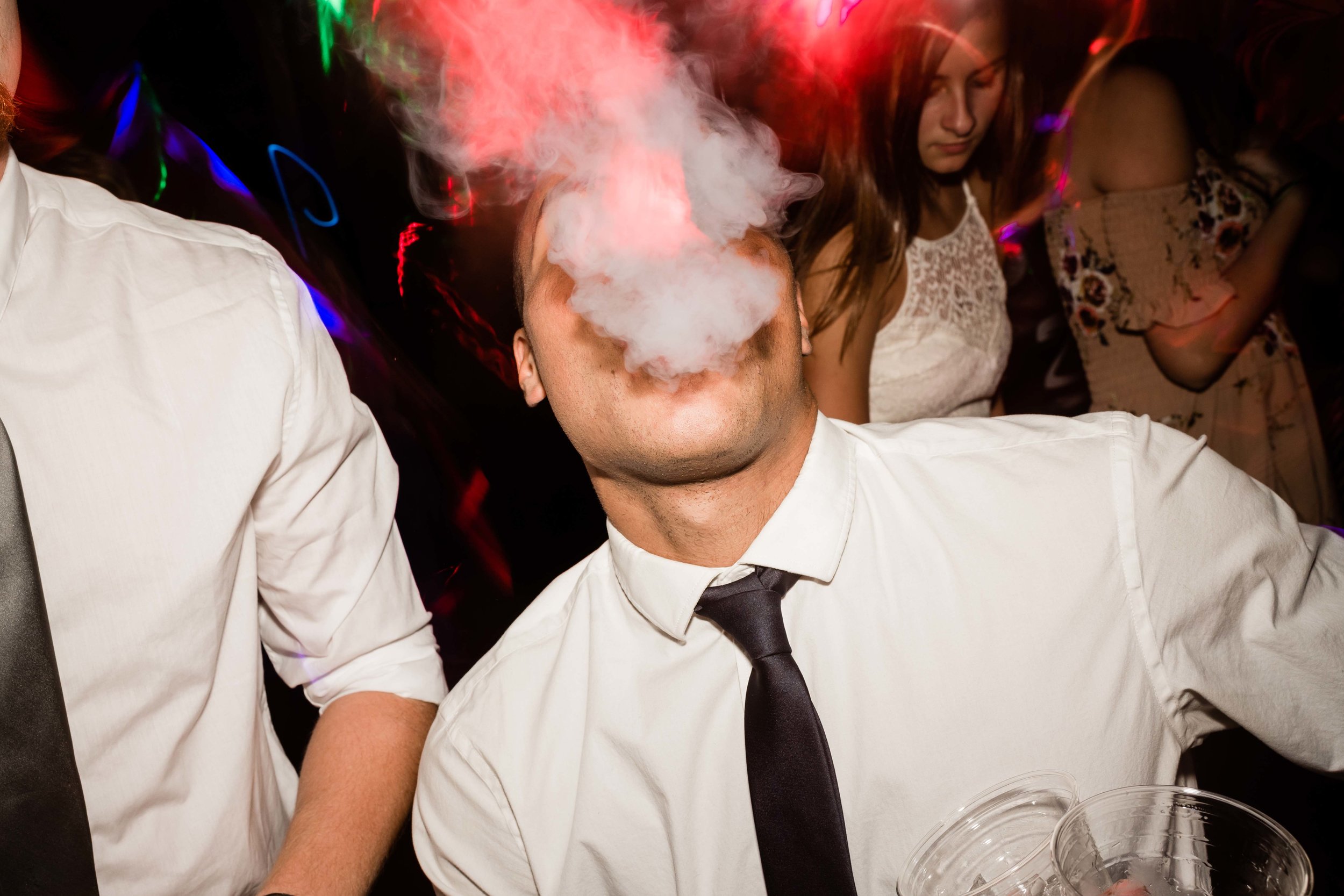 Wedding guest vaping on the dance floor