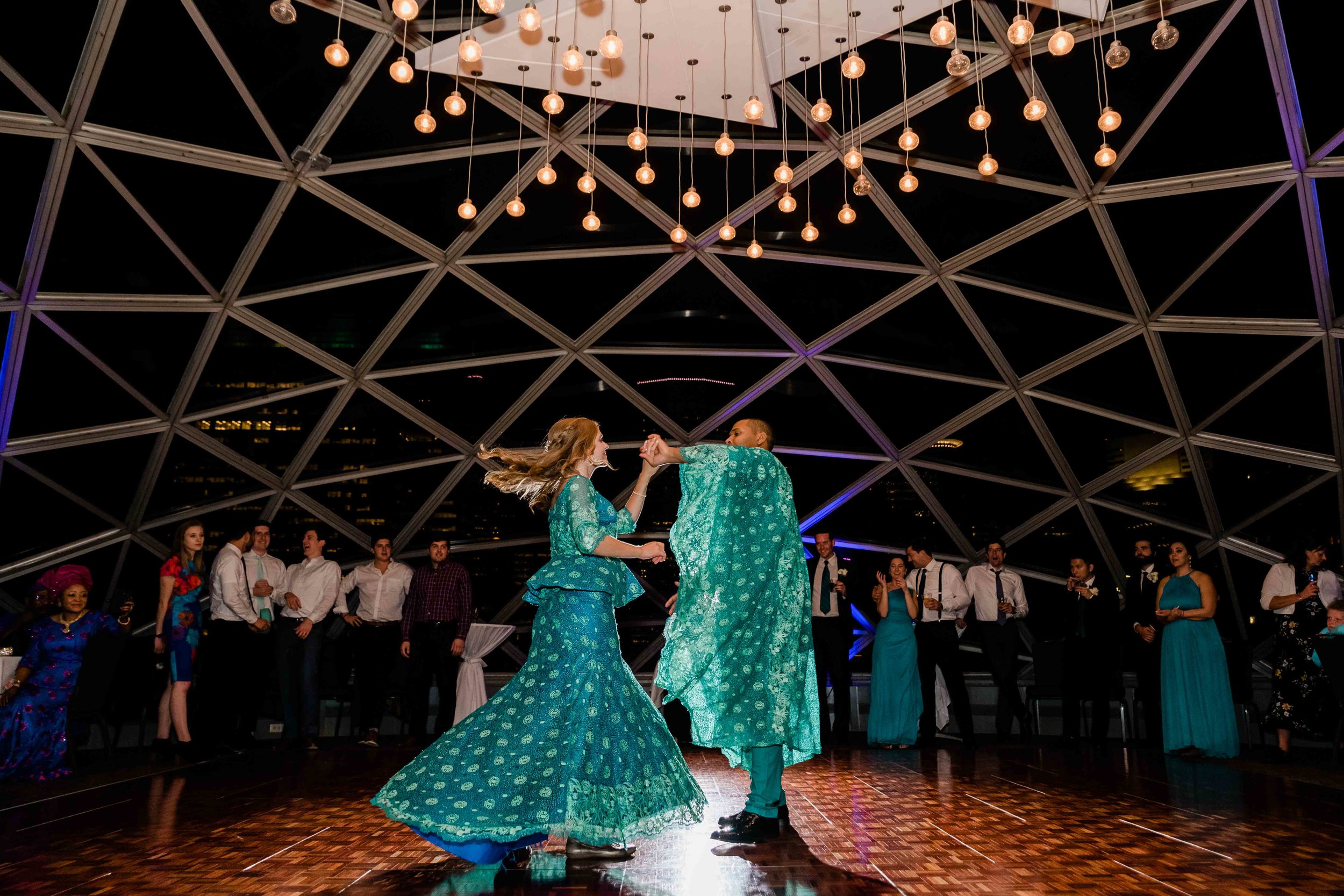 Groom spins bride around during first dance