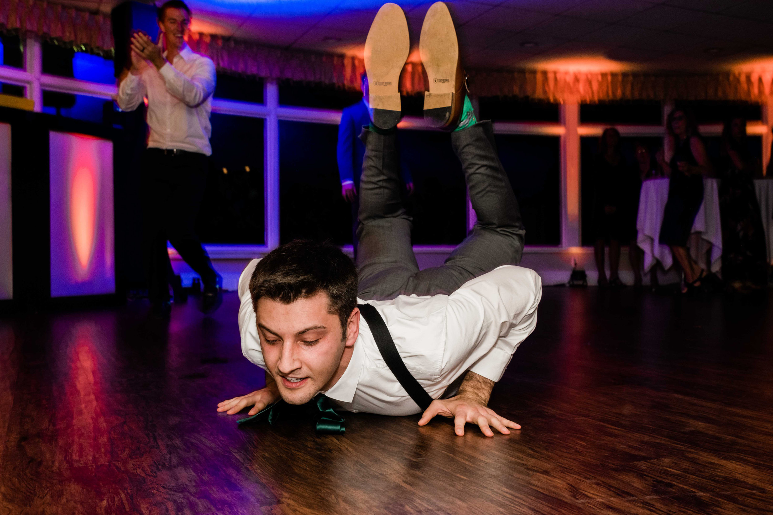 Groom doing the worm on the dance floor