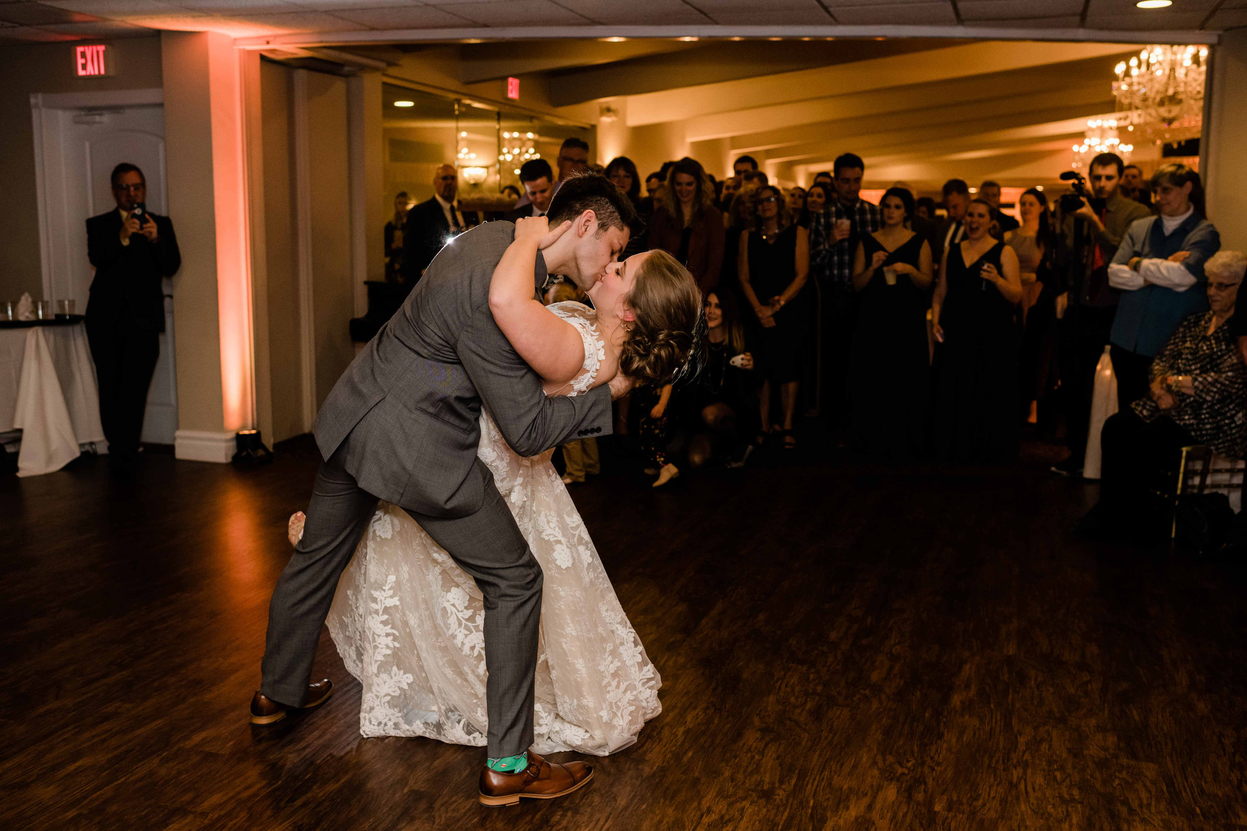 Groom dips his bride back during their first dance