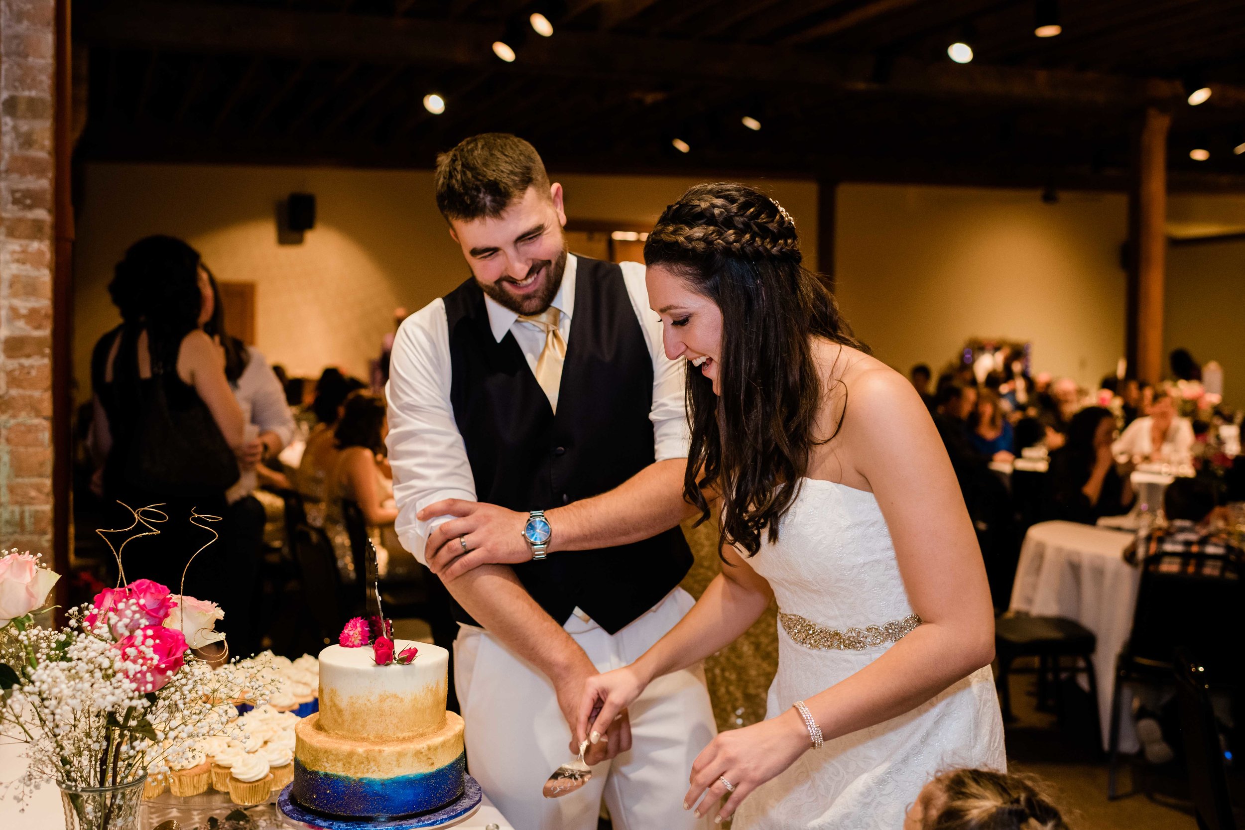 Bride and groom cutting their wedding cake