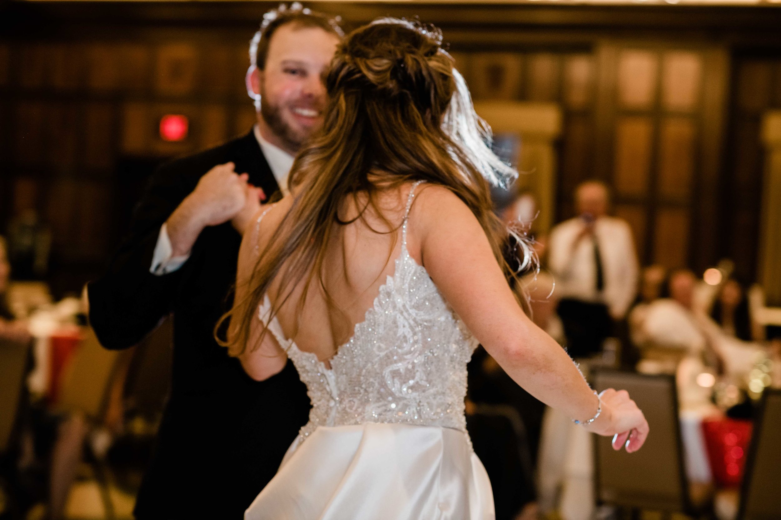 Groom twirling bride on the dance floor