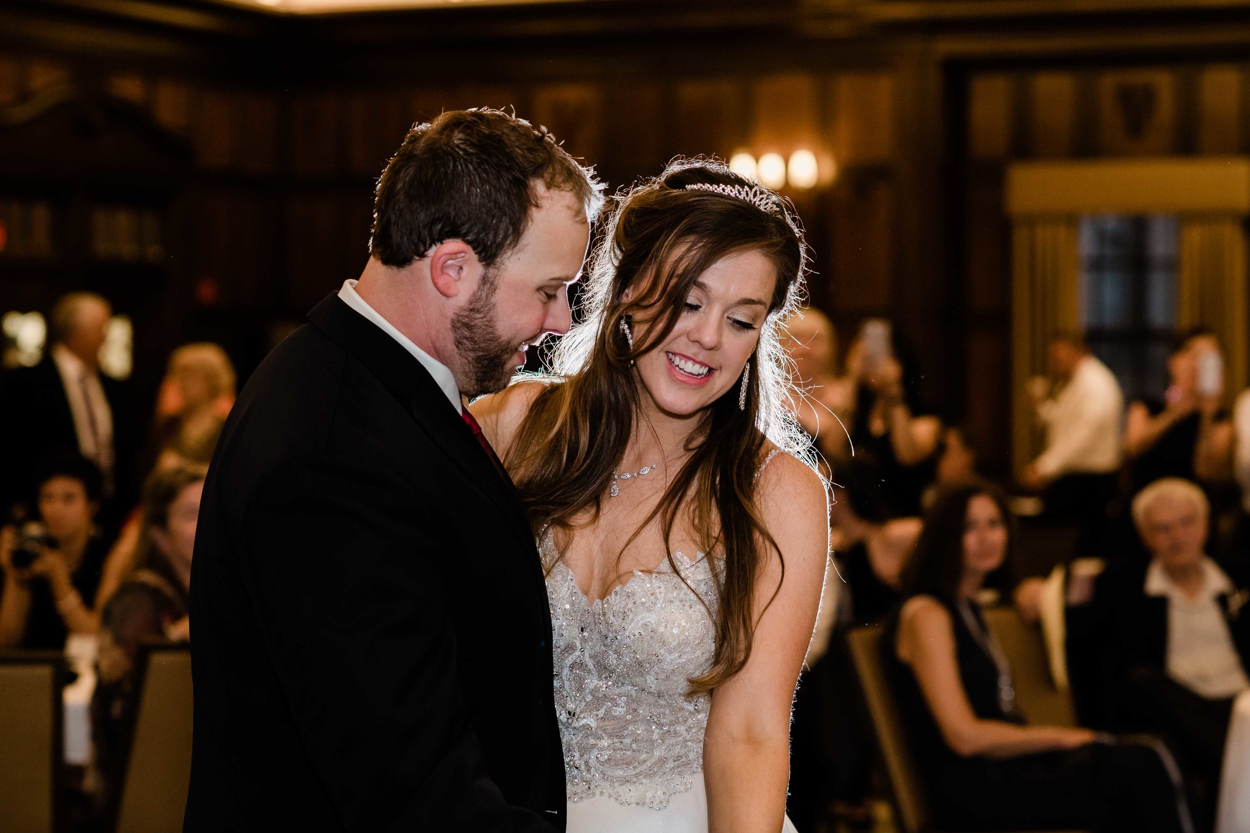 Backlit bride and groom dancing