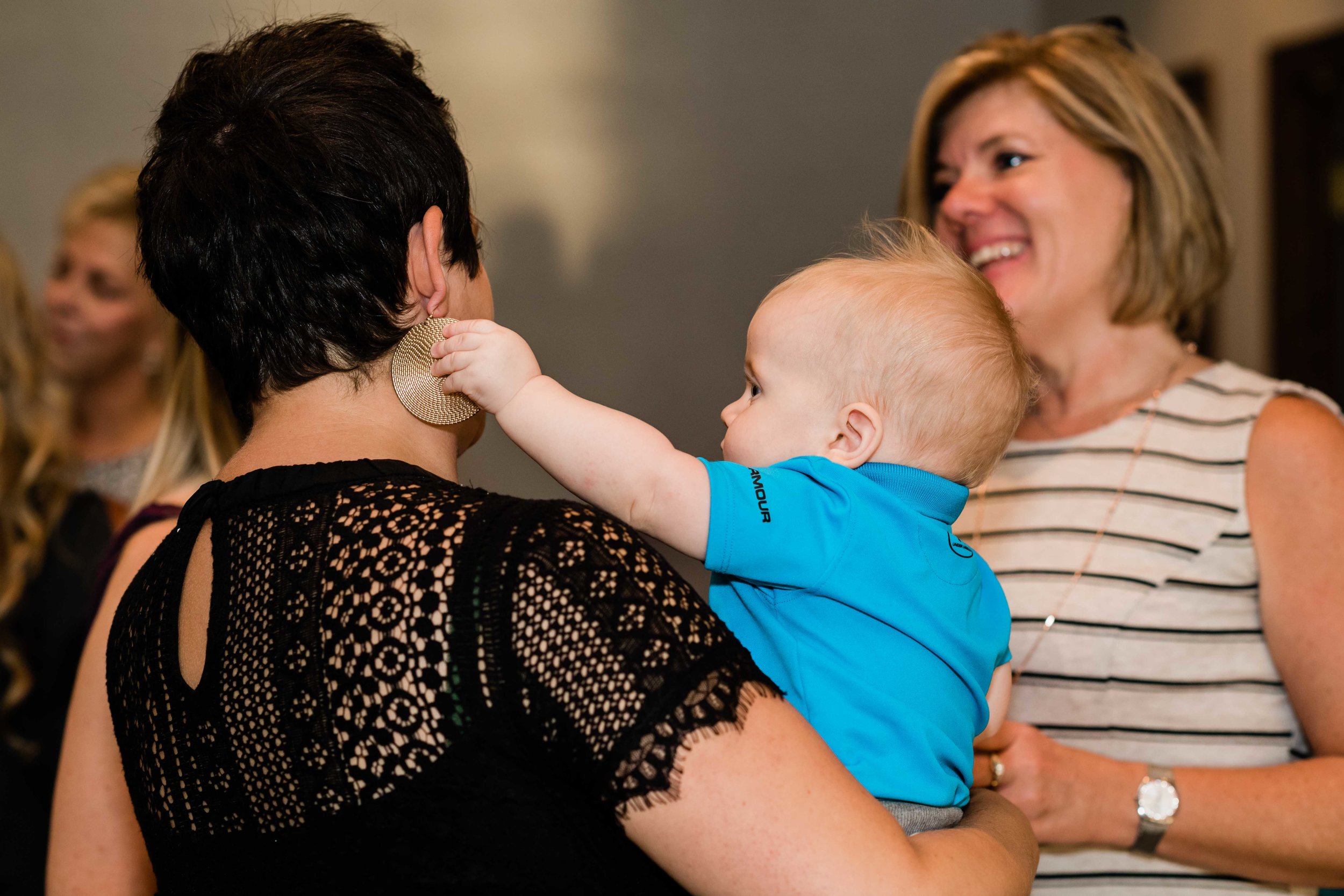 Baby plays with wedding guest's earring