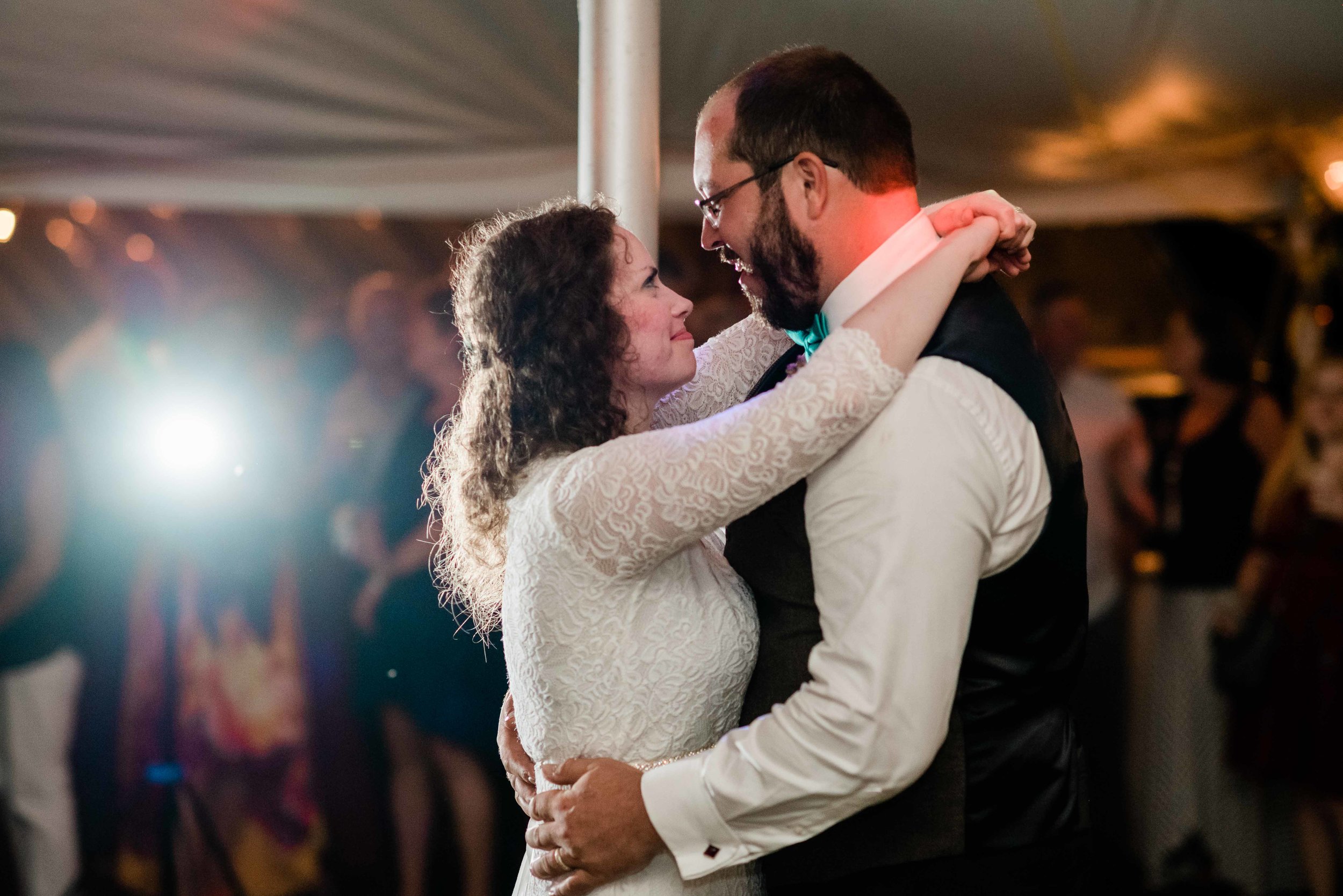 Bride and groom look into each other's eyes during first dance