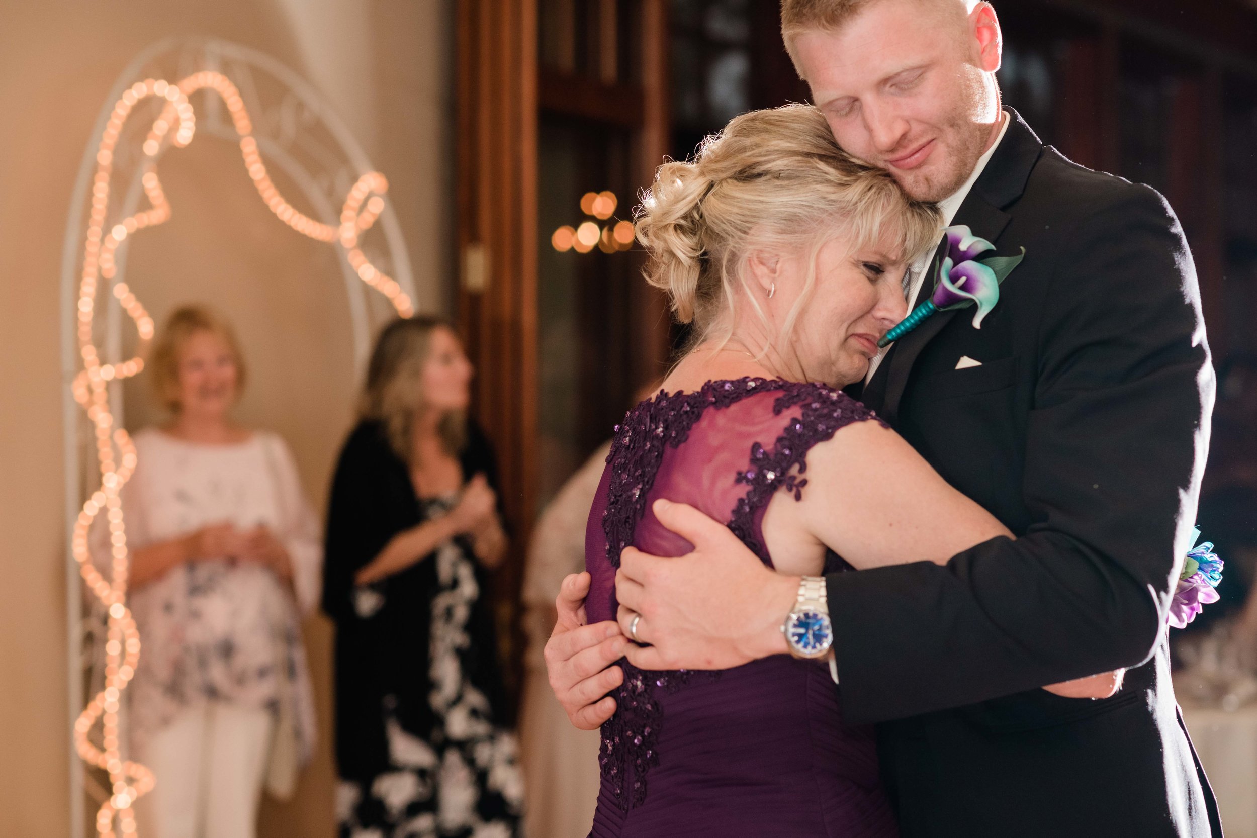 Mother of groom tearing up as she dances with her son