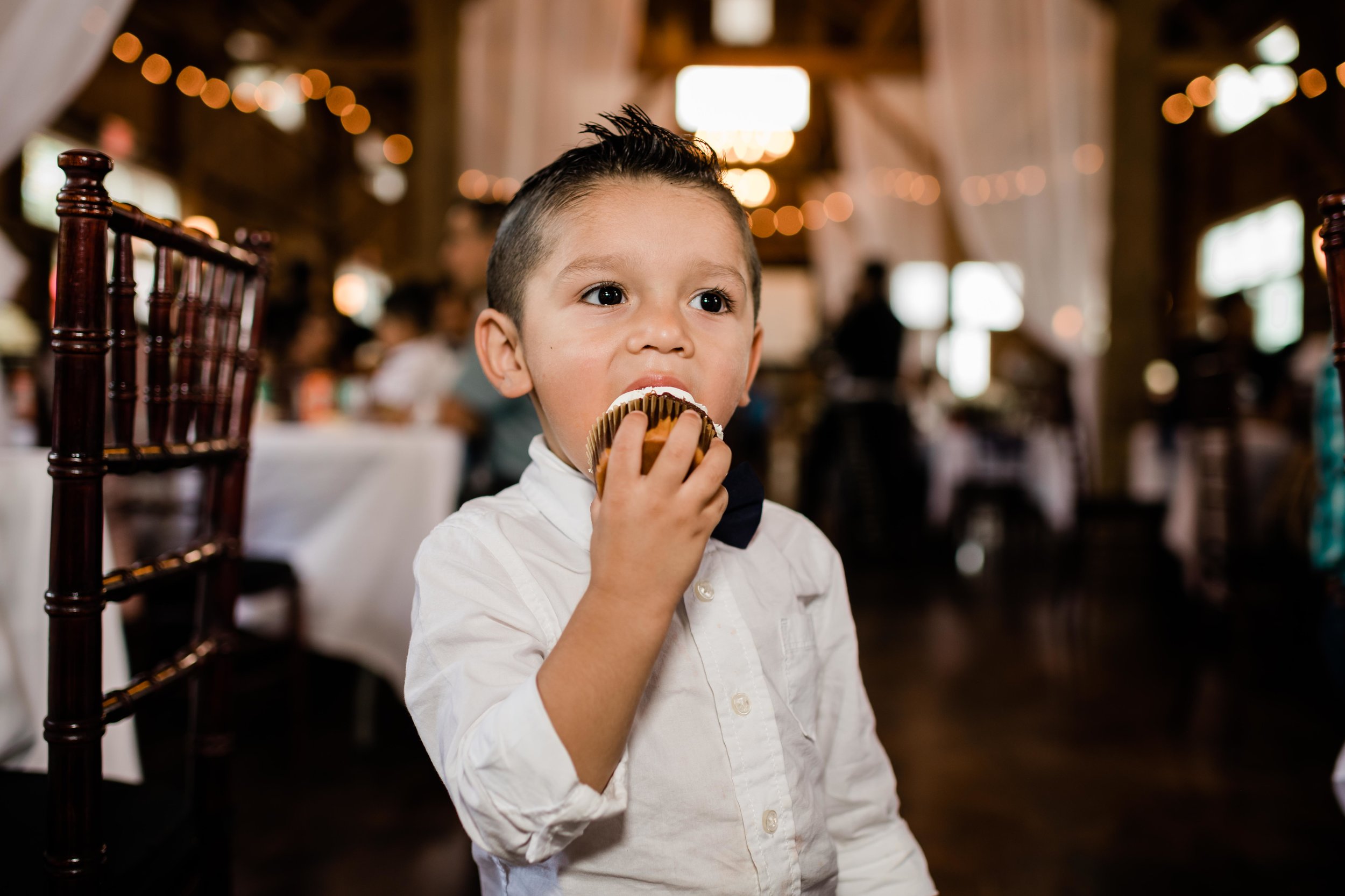 Child eating wedding cupcake