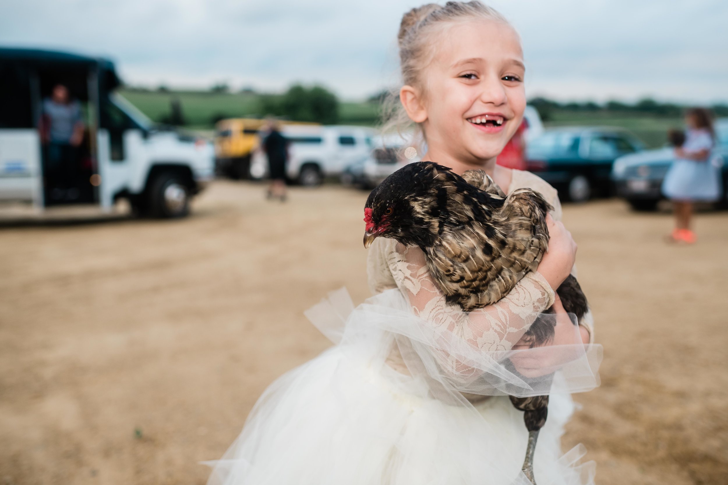 Flower girl holding a rooster