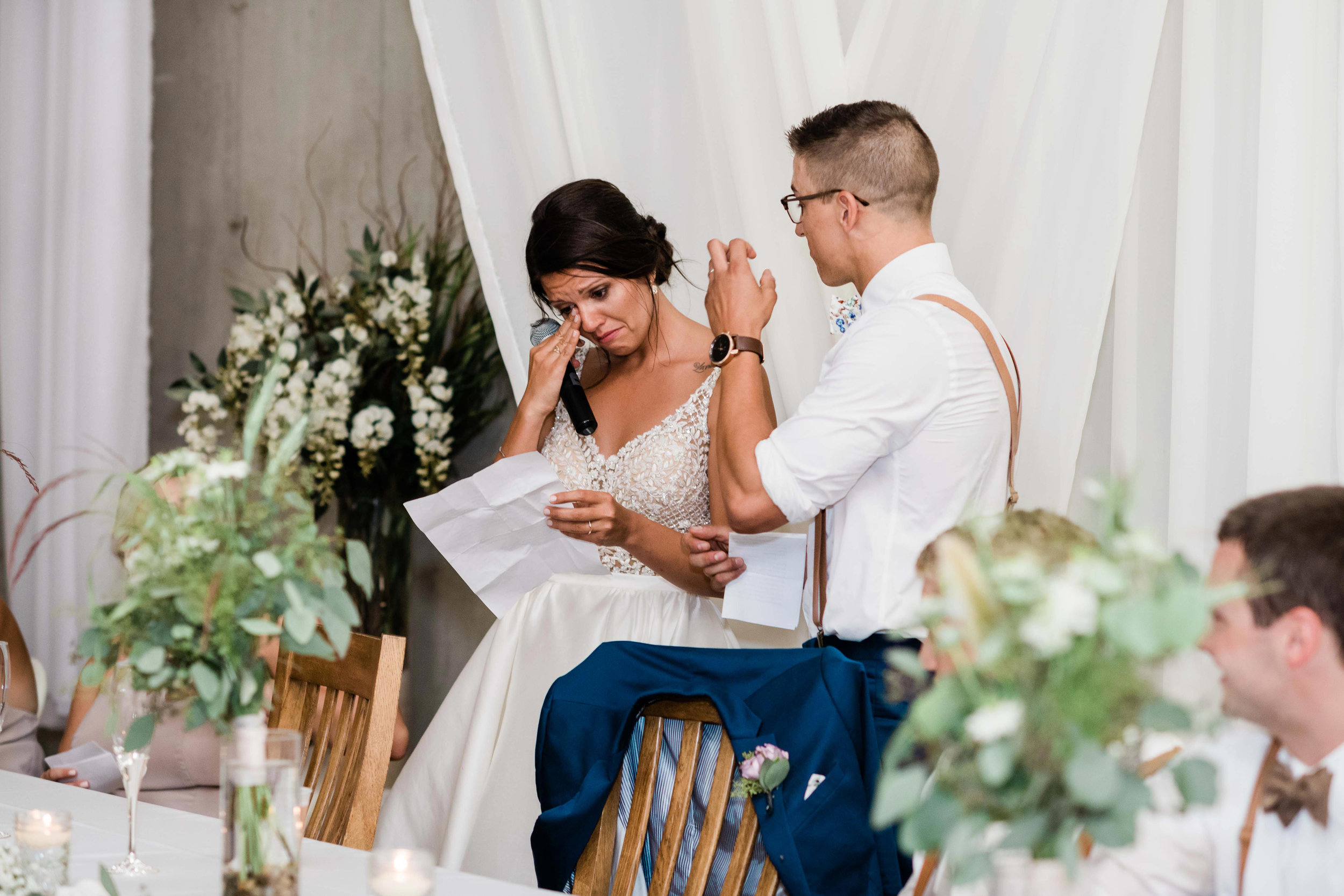 Bride wipes away tears as she gives a thank you speech