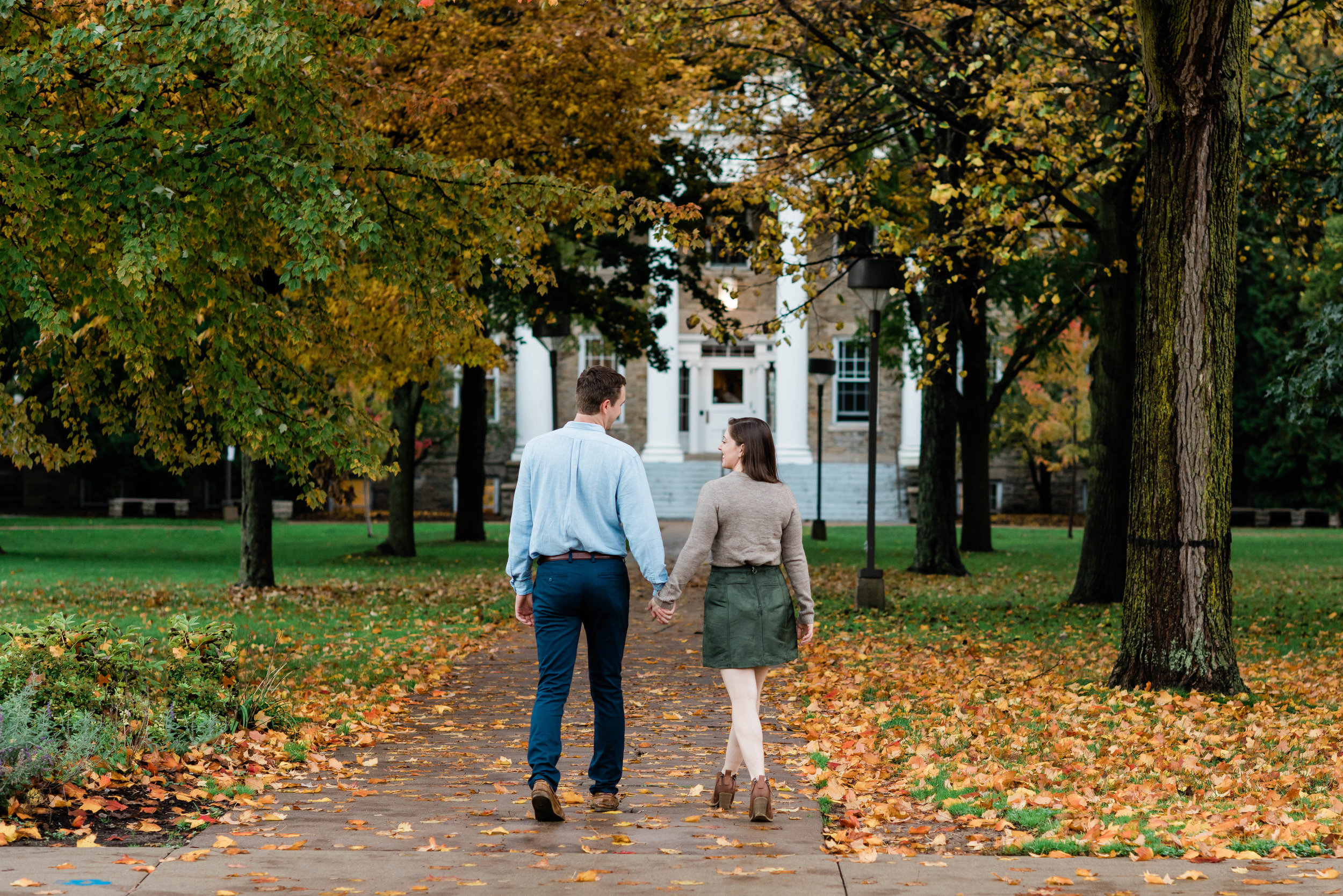 Engaged couple walking in the fall